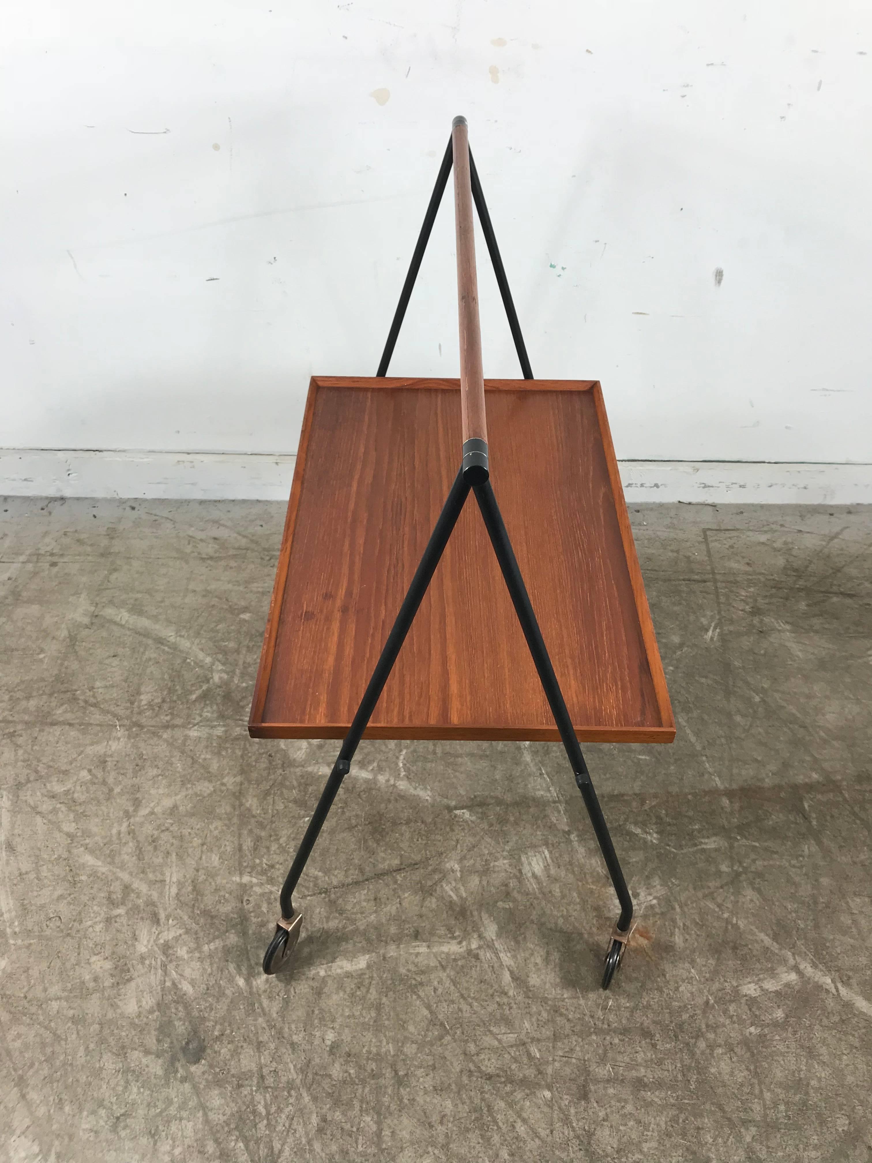 Stylized teak and iron tray table or bar cart by Cosack, stunning, classic European design, folds and collapses for easy storage, nice original condition, finish and patina. Table measures 17