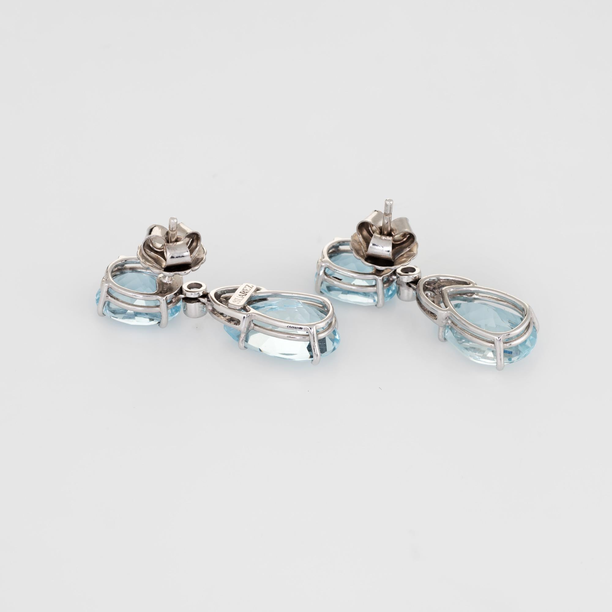Stylish pair of Suarez aquamarine & diamond drop earrings crafted in 18k white gold. 

Aquamarines measure 11mm x 9mm (estimated at 3.50 carats each - 7 carats total estimated weight). The lower pear cut aquamarines measure 15mm x 10mm (estimated at
