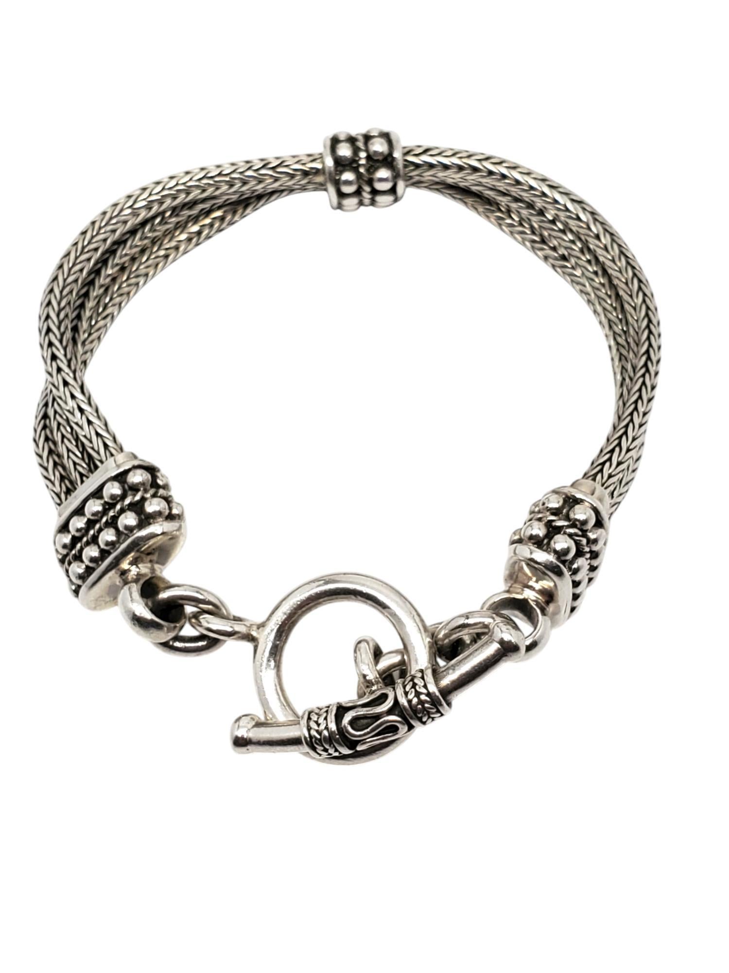 Suarti Sterling Silver Hand Woven 3 Chain Bracelet -

This heavy sterling silver bracelet features 3 stations of silver balls connected to 3 wheat chains with a toggle clasp by Suarti.

Size: 8 in.

14.6 mm at widest

Stamped: INDONESIA 925