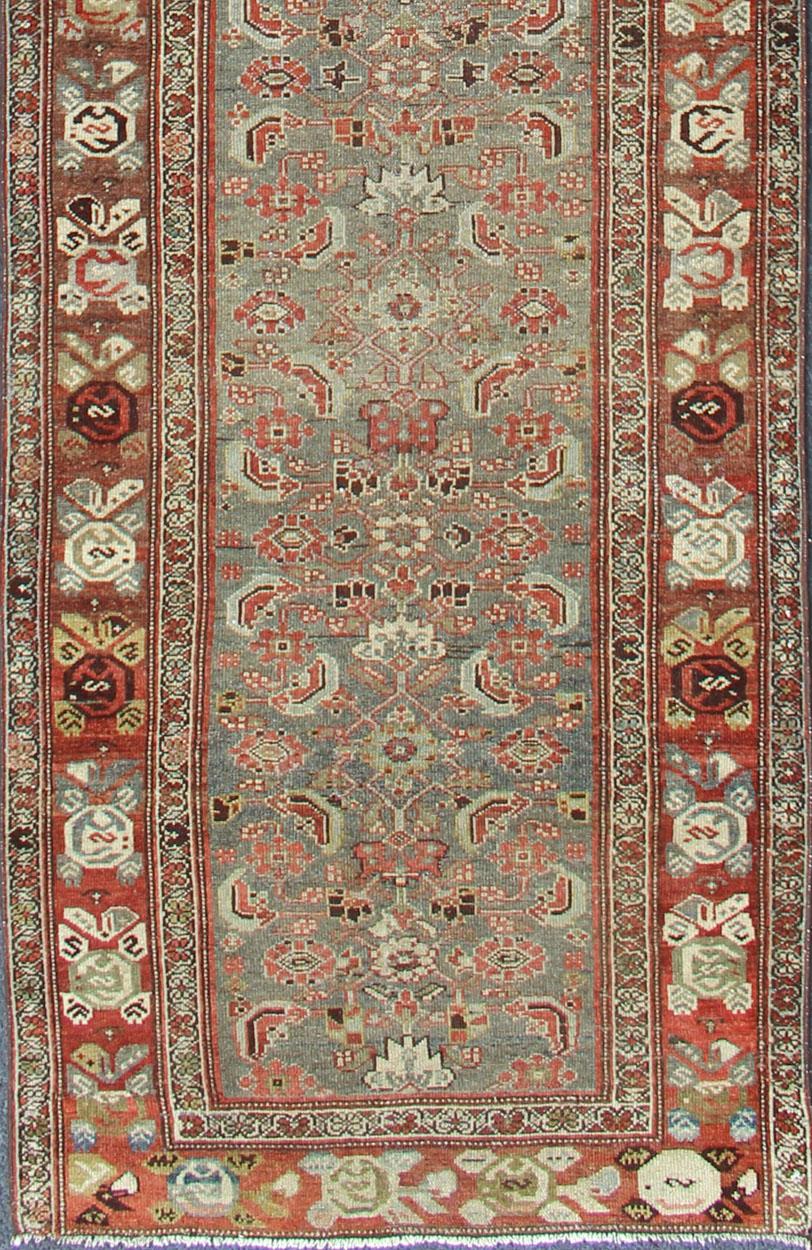 variation of light colors gray, green, blue background and soft red-colored border Persian Kurdish antique runner in Tribal all over Herati design with geometric motifs, rug KBE-200203, country of origin / type: Iran / Kurdish, circa 1910.  Keivan