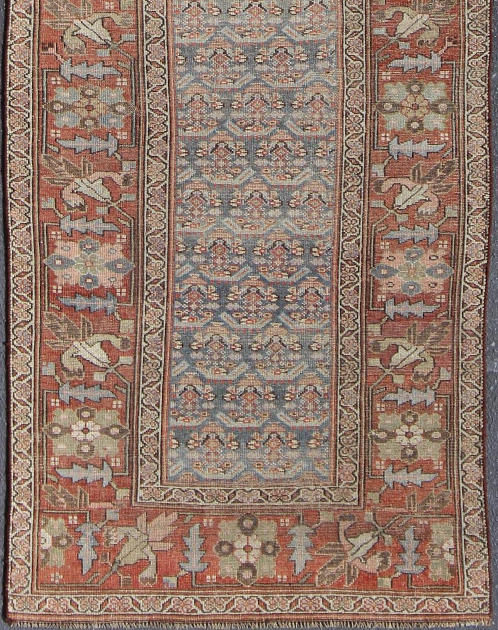 Gray background and soft red-colored Persian Kurdish antique runner in Tribal design with geometric motifs, rug 19-0105, country of origin / type: Iran / Kurdish, circa 1900.

This antique Kurdish tribal rug was woven by Kurdish weavers in western