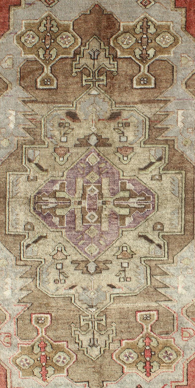 Measures 3'9 x 7'6

This vintage Turkish Oushak carpet, circa mid-20th century features a central, multi-layered medallion design, as well as patterns of smaller tribal and Sub-geometric elements in the four cornices, and in the surrounding borders.