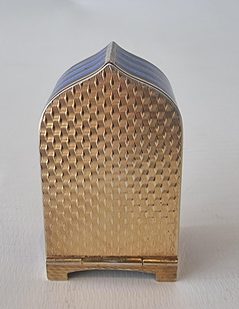 A superb sub miniature silver and blue guilloche white black enamel striped carriage or boudoir clock. Unusual shaped case and dial, the silvered dial with arabic numerals and blued steel hands, the three quarter plate, 8 day movement with integral
