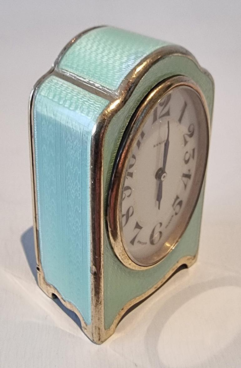 A very pretty silver gilt guilloche enamel sub miniature carriage or boudoir clock of unusual colour, eau de nil, a superb colour that has a gorgeous fleuressence that changes in the light. The enamel in superb condition report fine engine turned