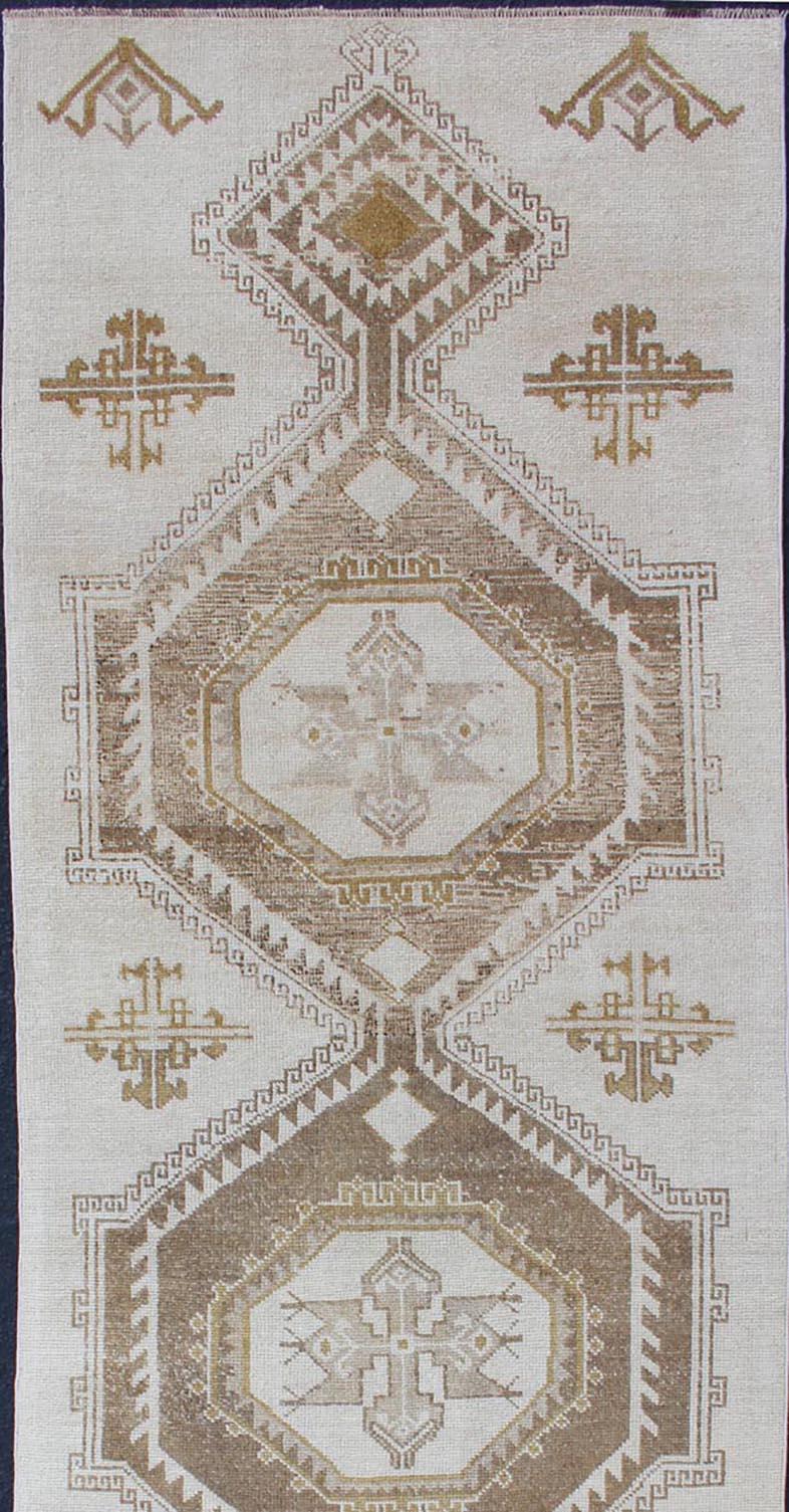 Subdued Vintage Turkish Oushak Runner with Medallions in Cream and Brown In Good Condition For Sale In Atlanta, GA