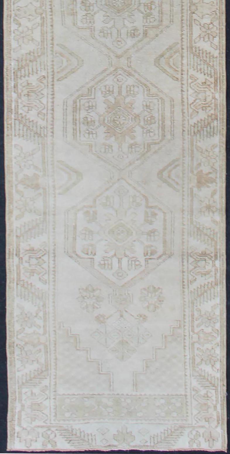 Hand-Knotted Subdued Vintage Turkish Oushak Runner with Medallions in Soft Cream For Sale