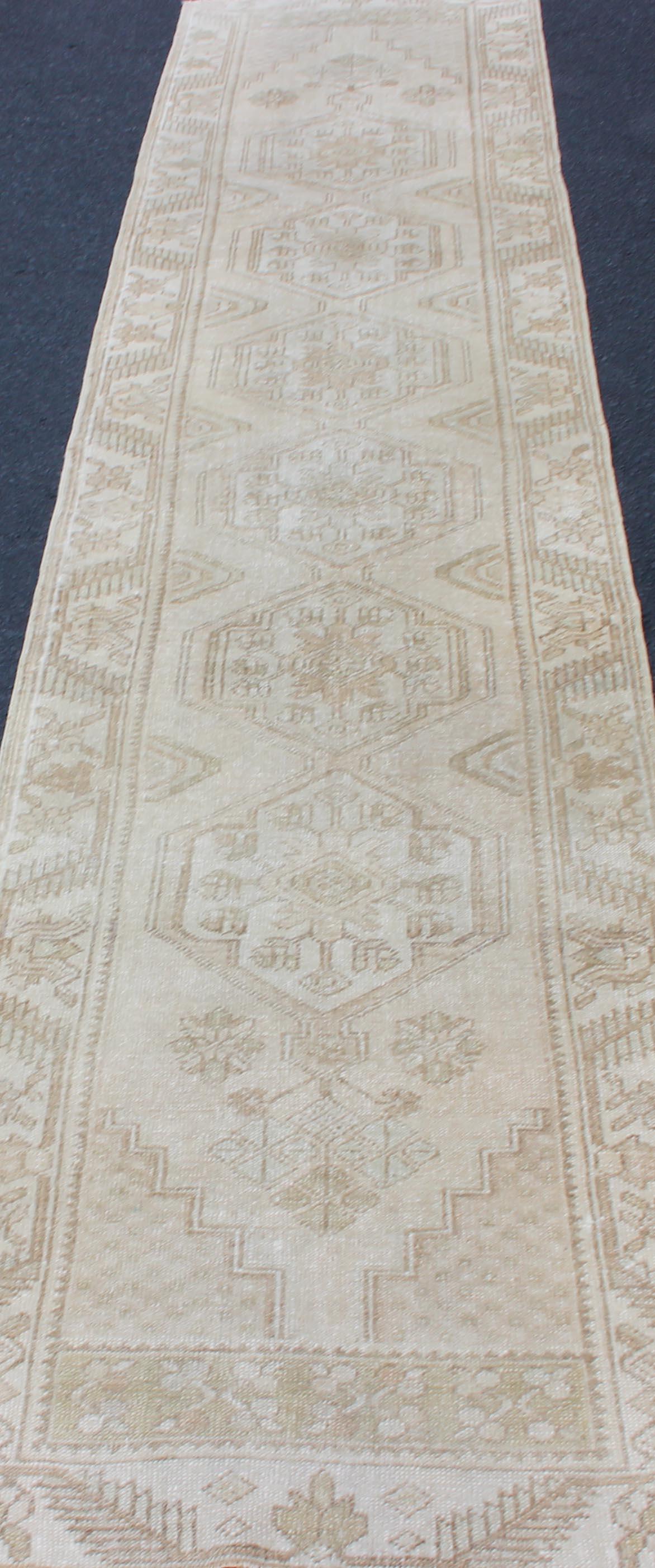 20th Century Subdued Vintage Turkish Oushak Runner with Medallions in Soft Cream For Sale