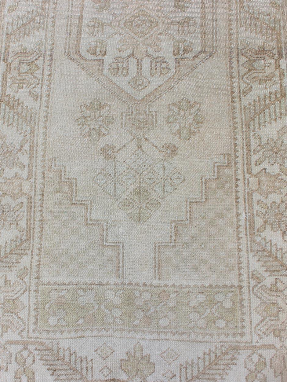 Wool Subdued Vintage Turkish Oushak Runner with Medallions in Soft Cream For Sale
