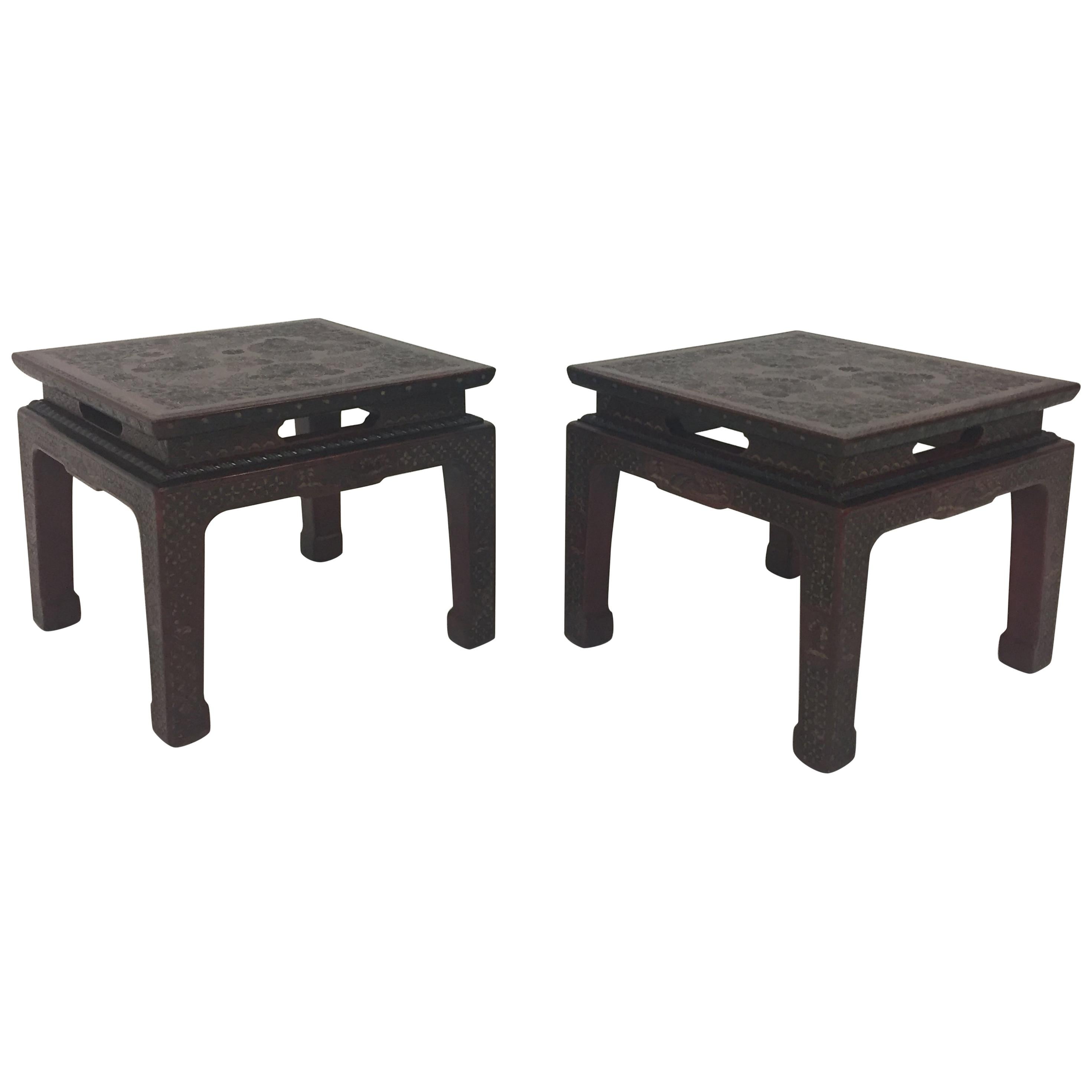 A gorgeous textured encised gesso over wood pair of end or side tables in a deep burgundy with intricate floral and geometric decoration and stunning Chinese sculpted legs.