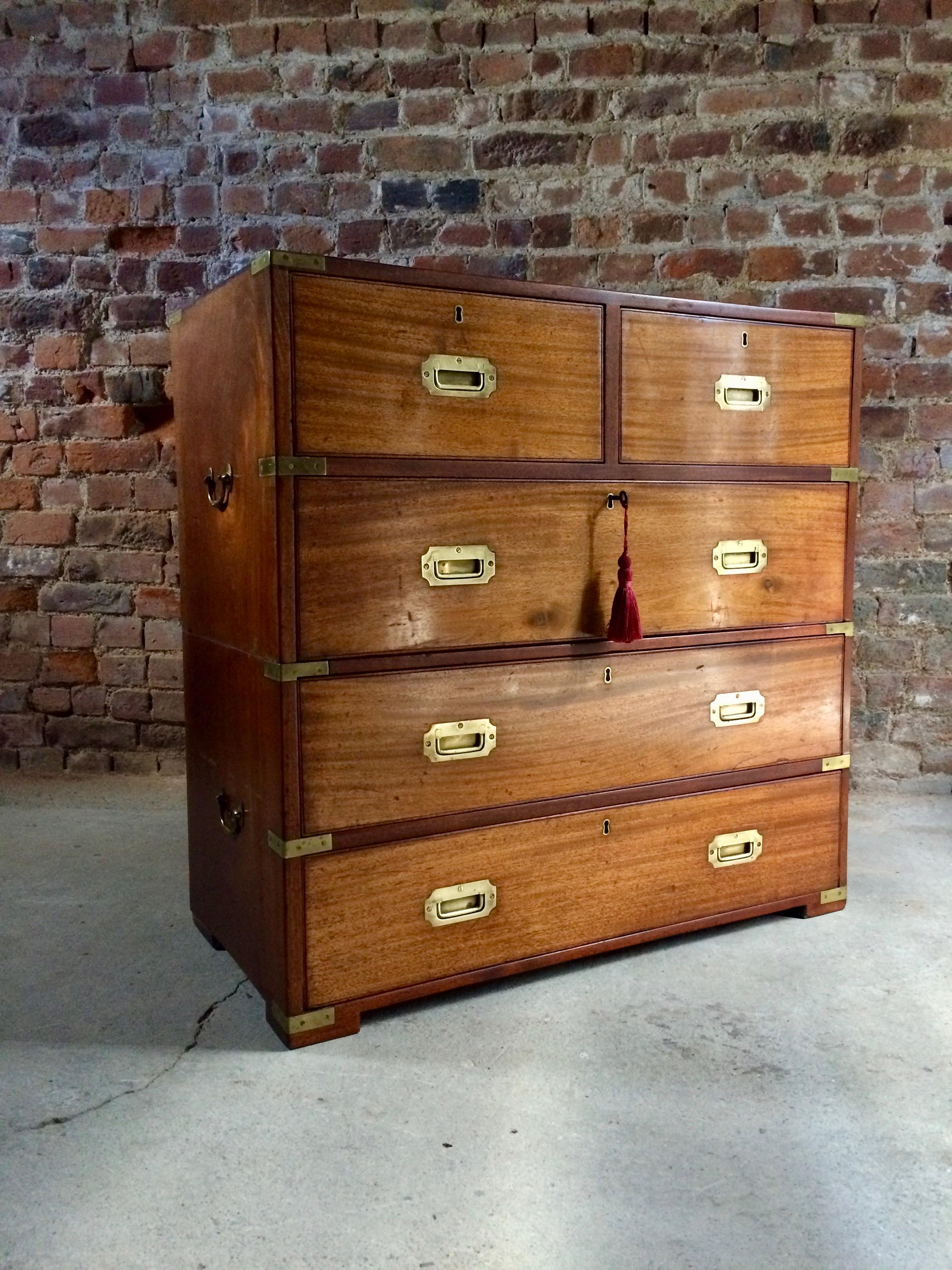 A beautiful smaller than average 19th century Victorian two section mahogany Campaign chest of drawers dating to circa 1875, The rectangular top over two short and three long drawers, raised on block feet, The chest features its original Campaign