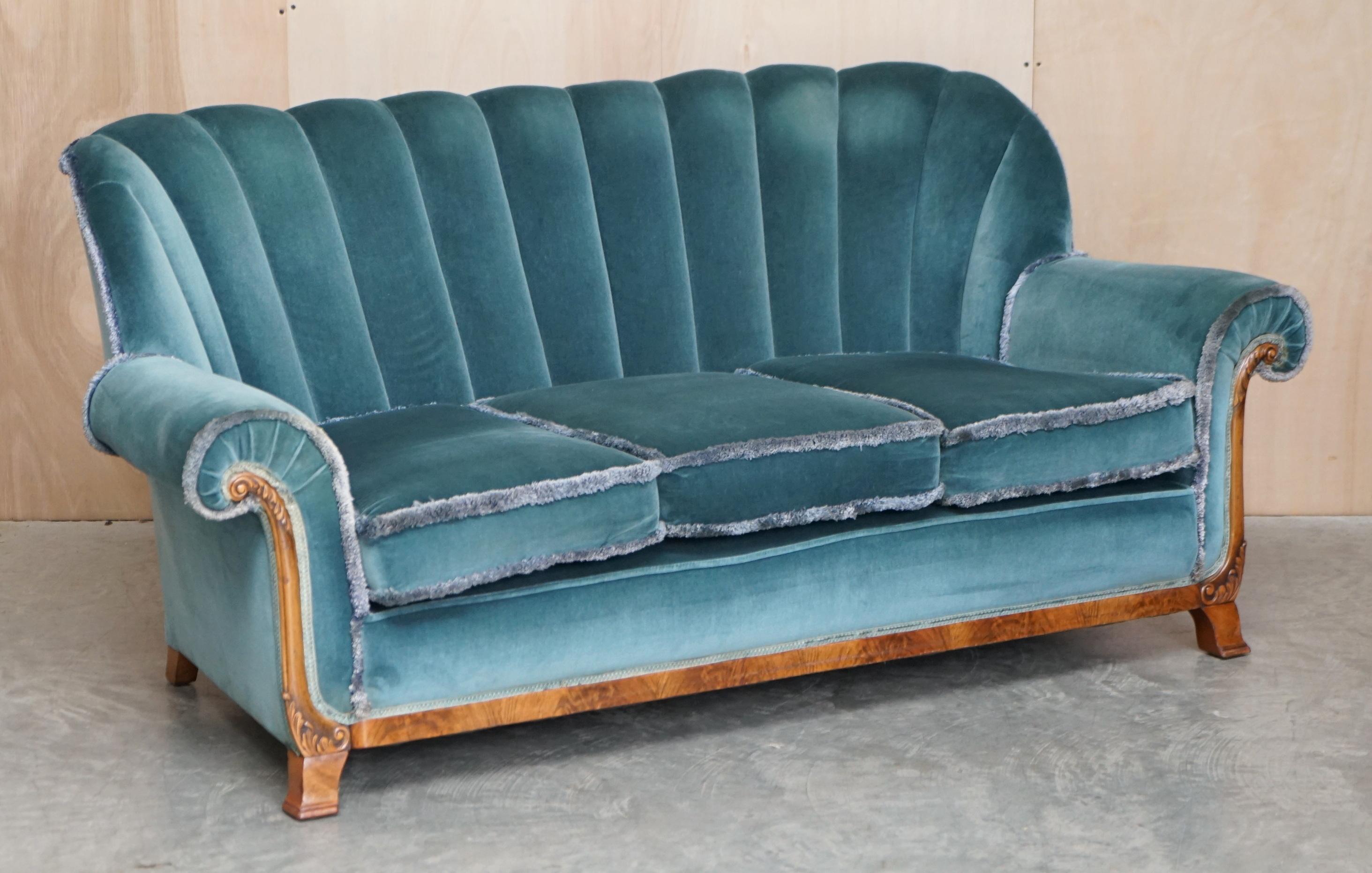 We are delighted to offer this exquisite circa 1920’s Art Deco Fluted back Walnut framed three piece suite with teal blue velour upholstery

A very good looking and well made suite, I purchased this with a view to reupholstering it in either