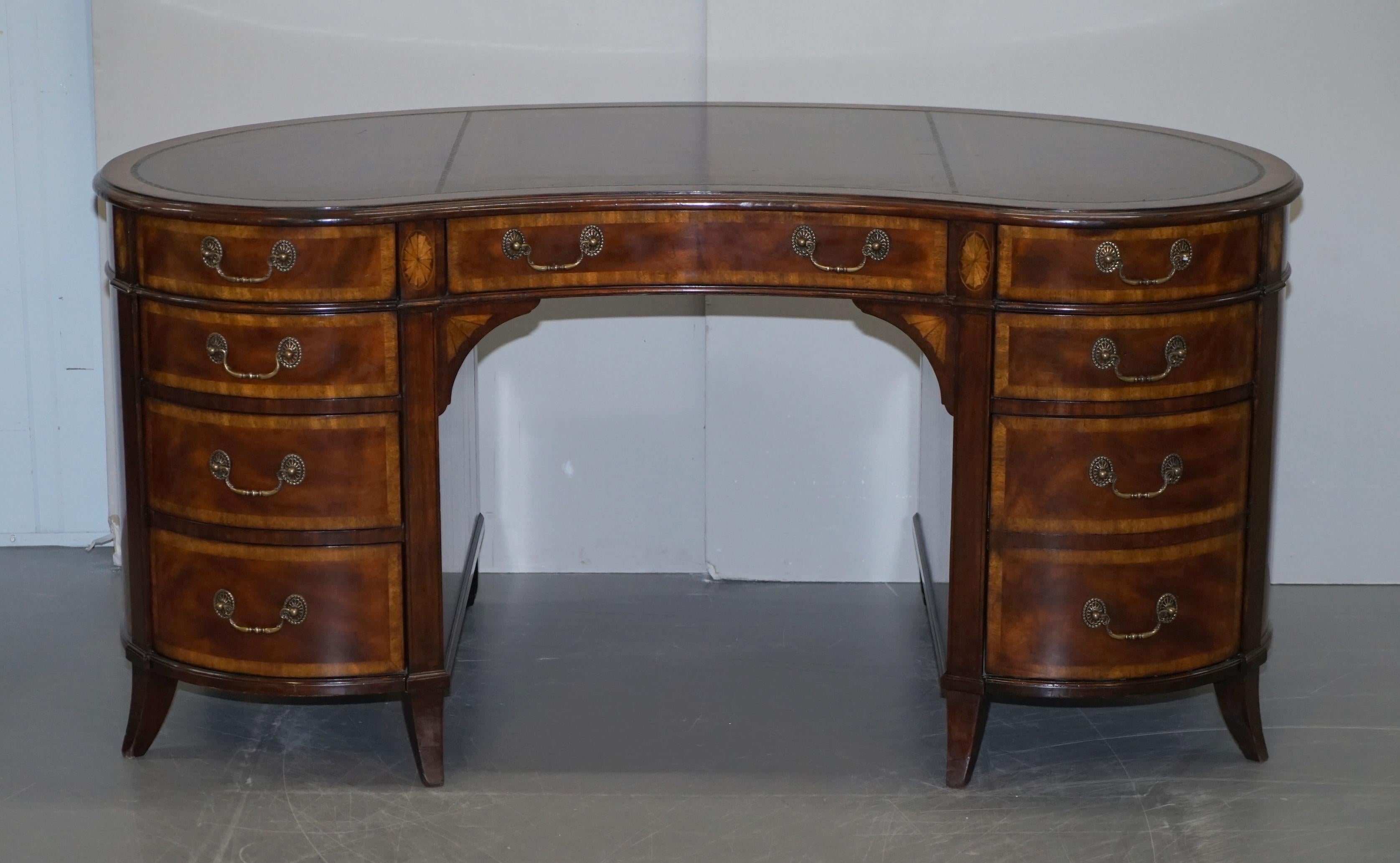 We are delighted to offer for sale this lovely handmade Crotch mahogany and walnut kidney desk with brown leather top

An exquisite looking and very well made piece. This desk is large and very heavy, the drawer linings are all solid oak and the