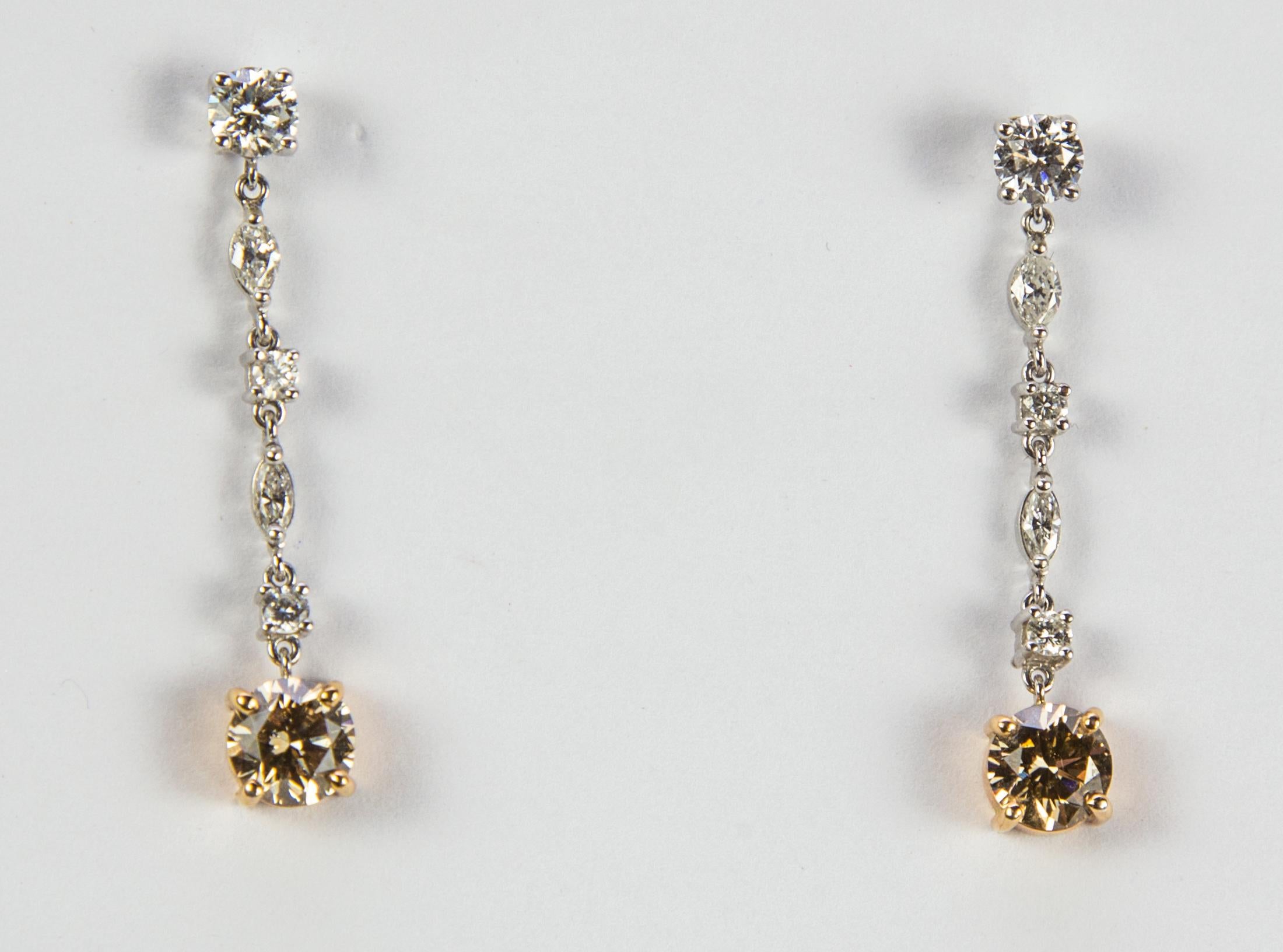 Featuring Fabulous one of a kind Diamond Earrings; hand crafted in 18K white and yellow gold, each earring set with one round brilliant-cut diamond, weighing approx. .25 carat (.50 total carat weight), suspending two marquise shaped diamonds, two