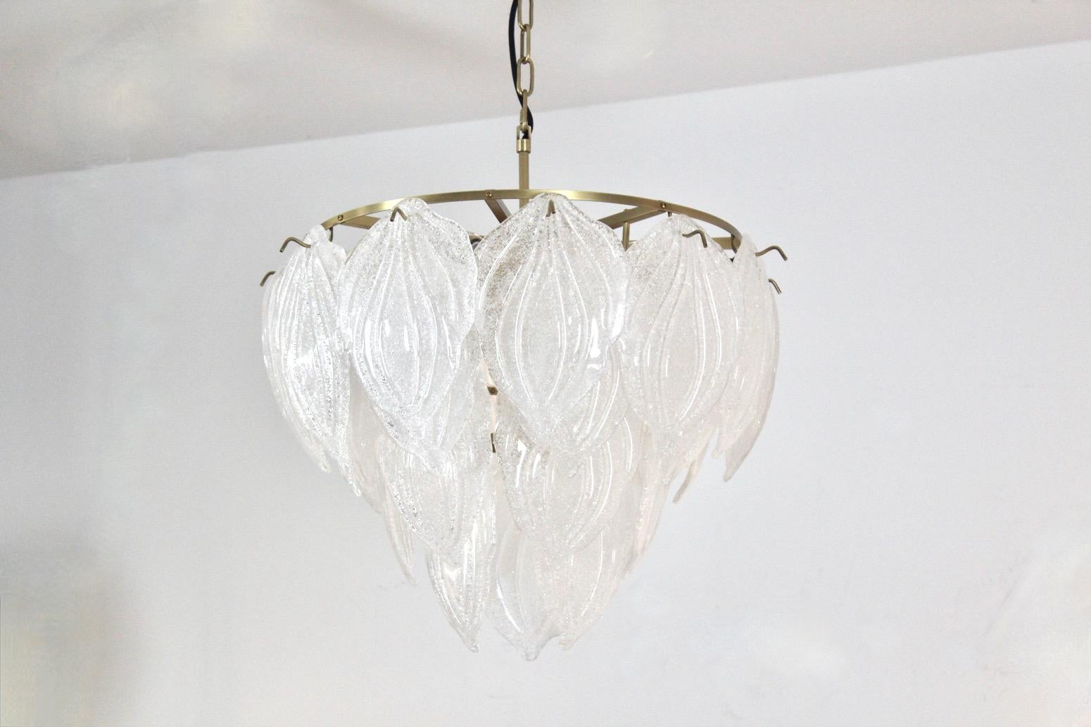 Wonderful chandelier made in Germany with 28 beautiful characteristic Frosted Glass Leaves on a Brass steel base with 9 lights. Very impressive large glass Chandelier and beautiful light effect when lit. In excellent condition

I have two matching
