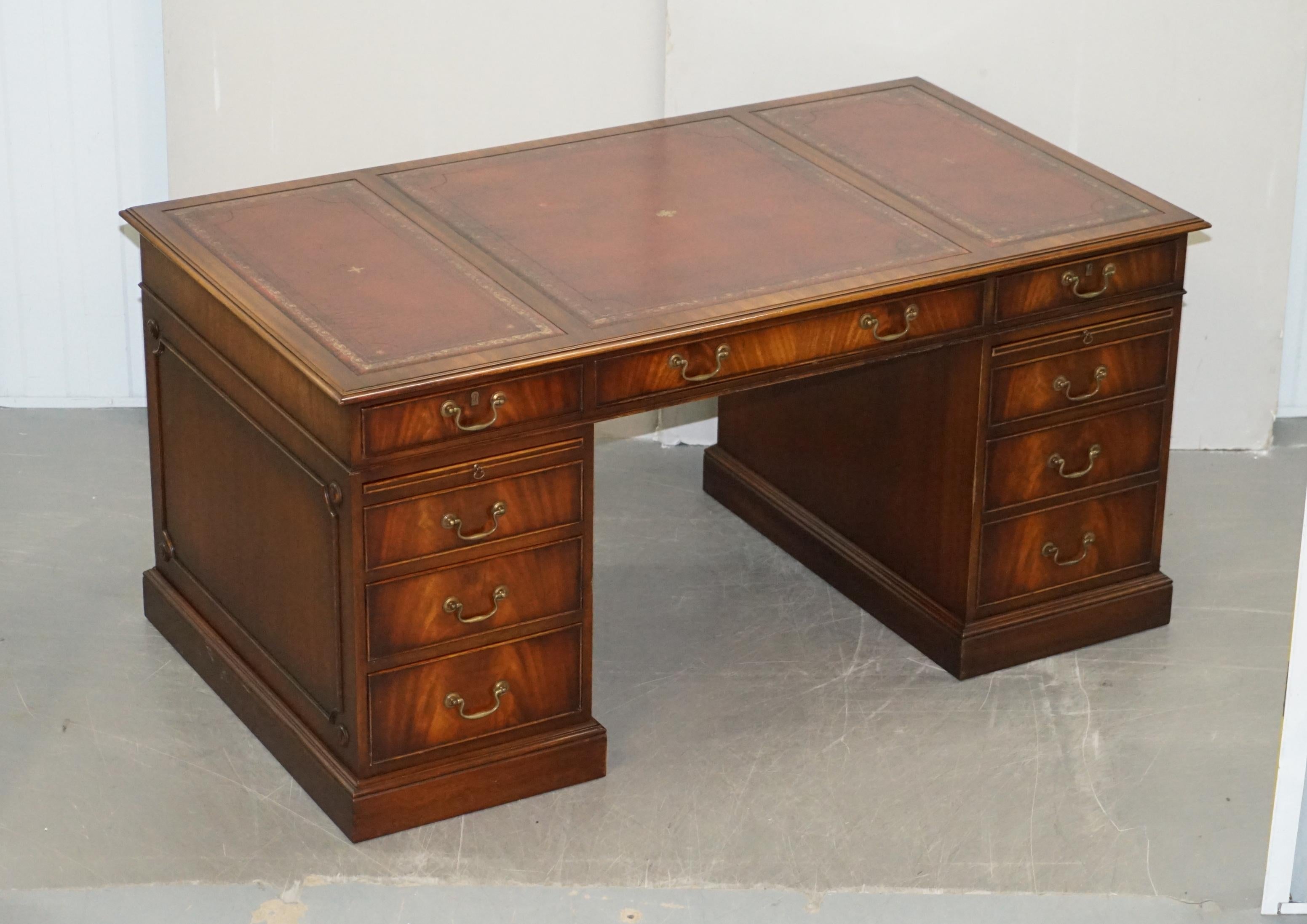 We are delighted to offer this exquisite vintage hand made mahogany twin pedestal partner desk with oxblood leather top and double butlers serving trays

A beautiful, desirable and a very unique piece, the desk is made with a lovely grain of