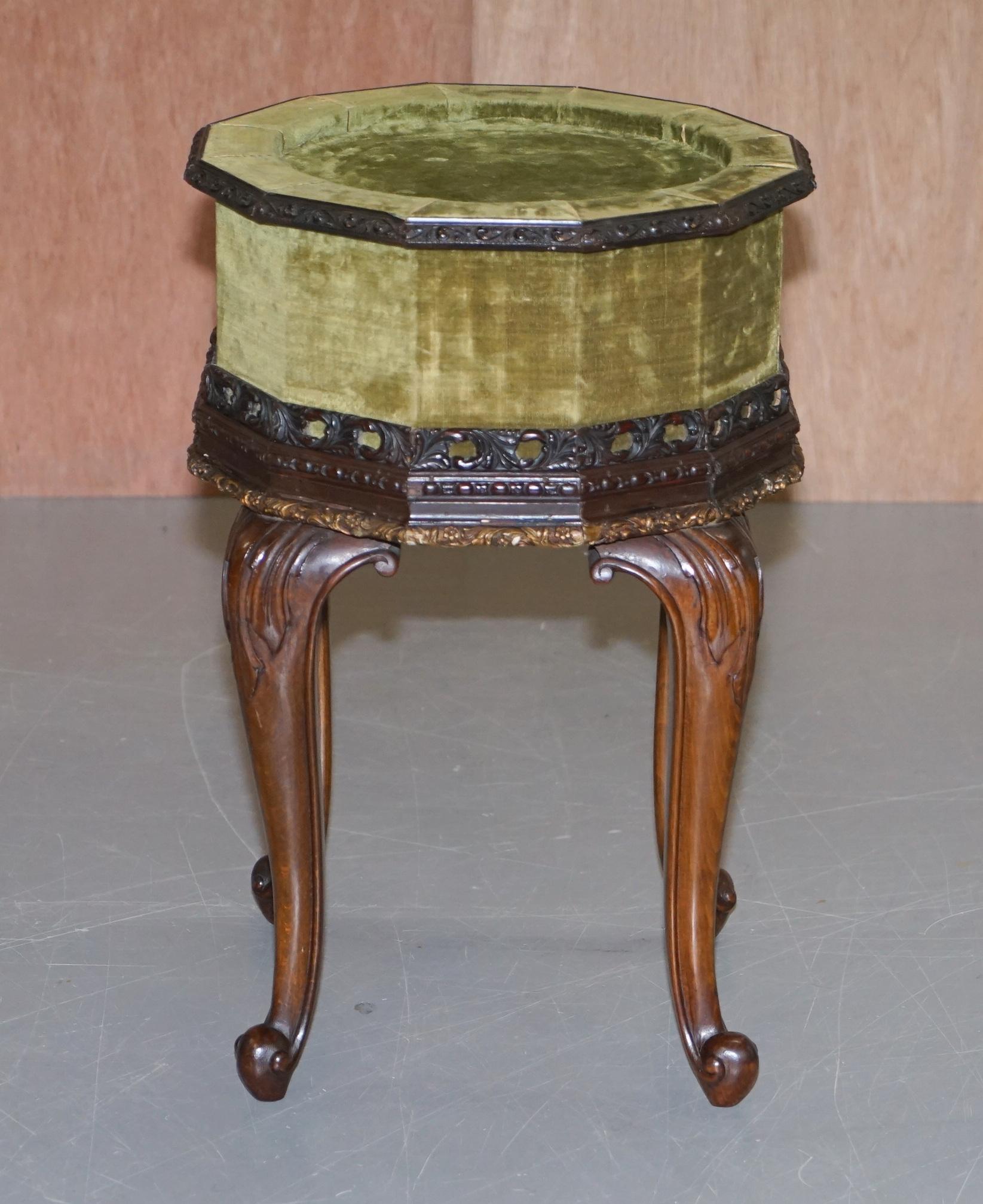 We are delighted to offer for sale this sublime pair of antique 19th century, 12 sided, side tables with hand carved mahogany frames and green velvet upholstery 

These are a very well made and decorative pair, ideally suited for plants or lamps,
