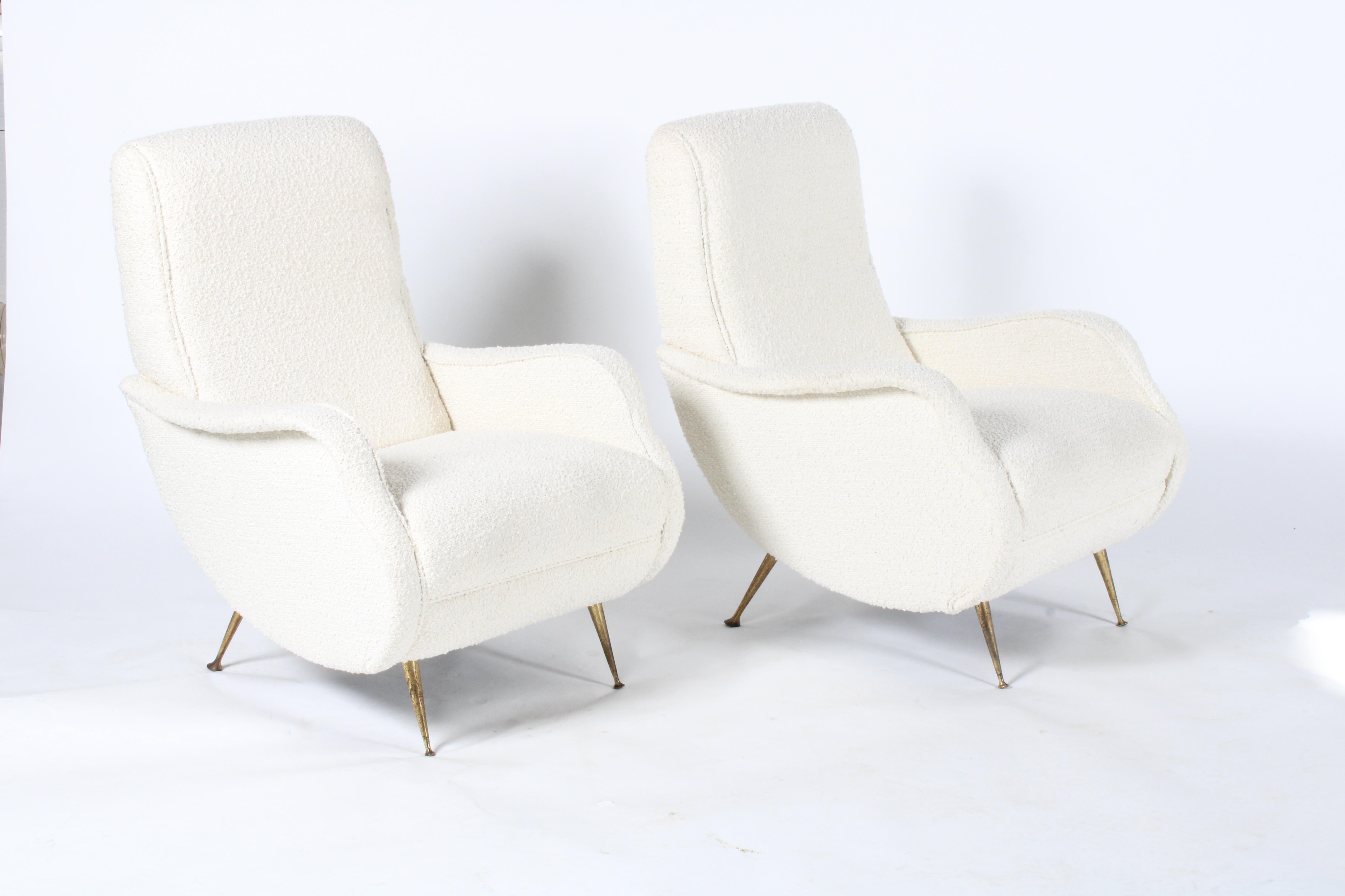 Sublime pair of original Mid-Century Modern Italian armchairs. Sourced in Modena Italy from a private collection this amazing pair have been newly upholstered in a chic bouclé type fabric. Sweeping super stylish curved armrests and sides almost give