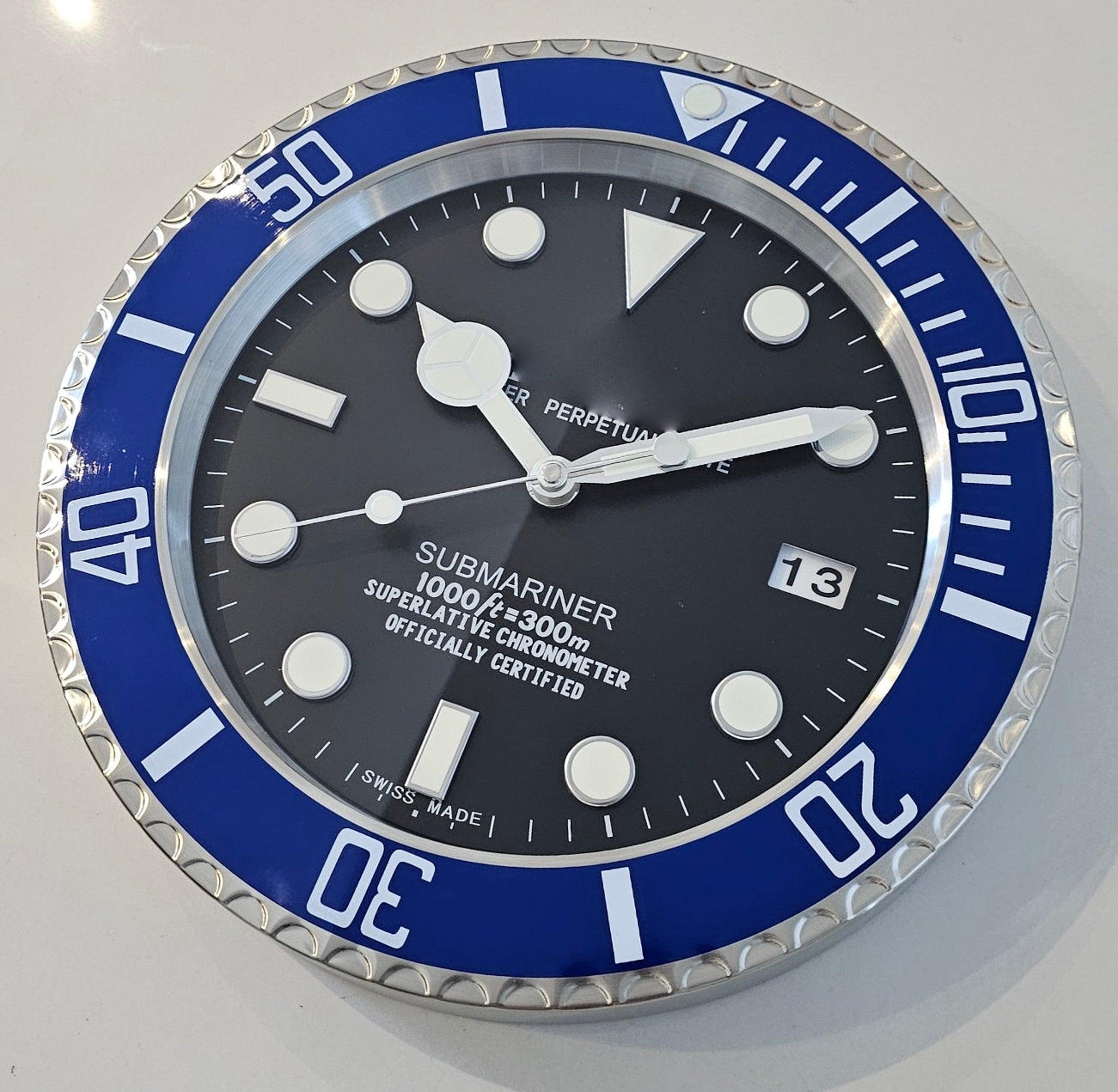 Submariner wall Clock.

This is a very decorative wall clock depicting the Submariner wristwatch. The wall clock has been crafted in Switzerland with parts made up in stainless steel, aluminum and glass. All accented with blue lacquer and black