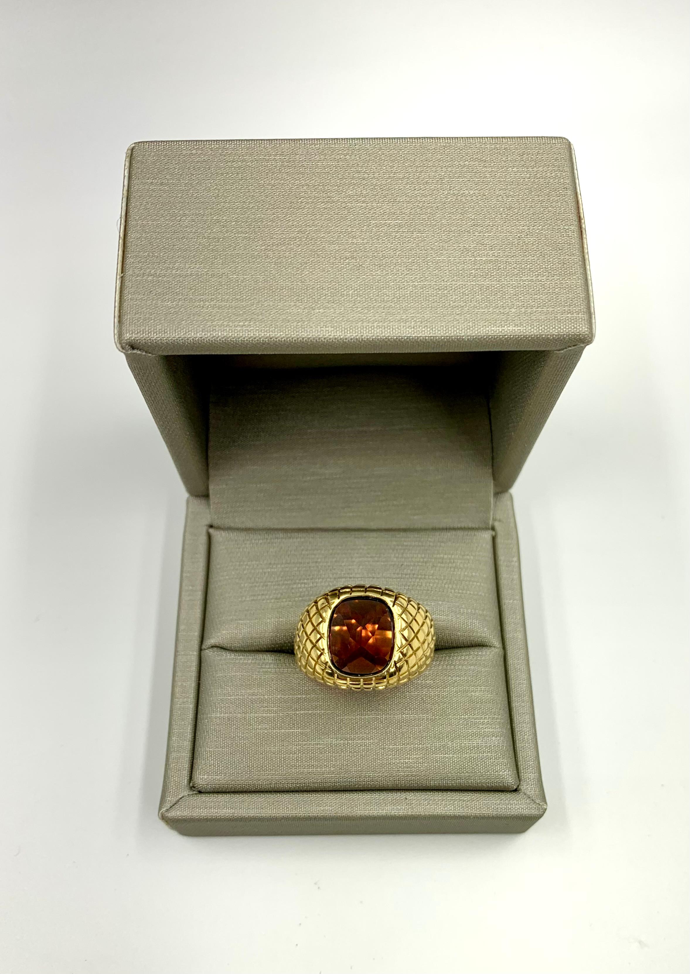 High quality 18K yellow gold rhombus box design garnet signet ring by ABL.
The fine oval Rhodolite garnet signet stone shows hidden fire as the pavillion of the gem is facet cut and the gold setting is open at the back to allow light to reflect,