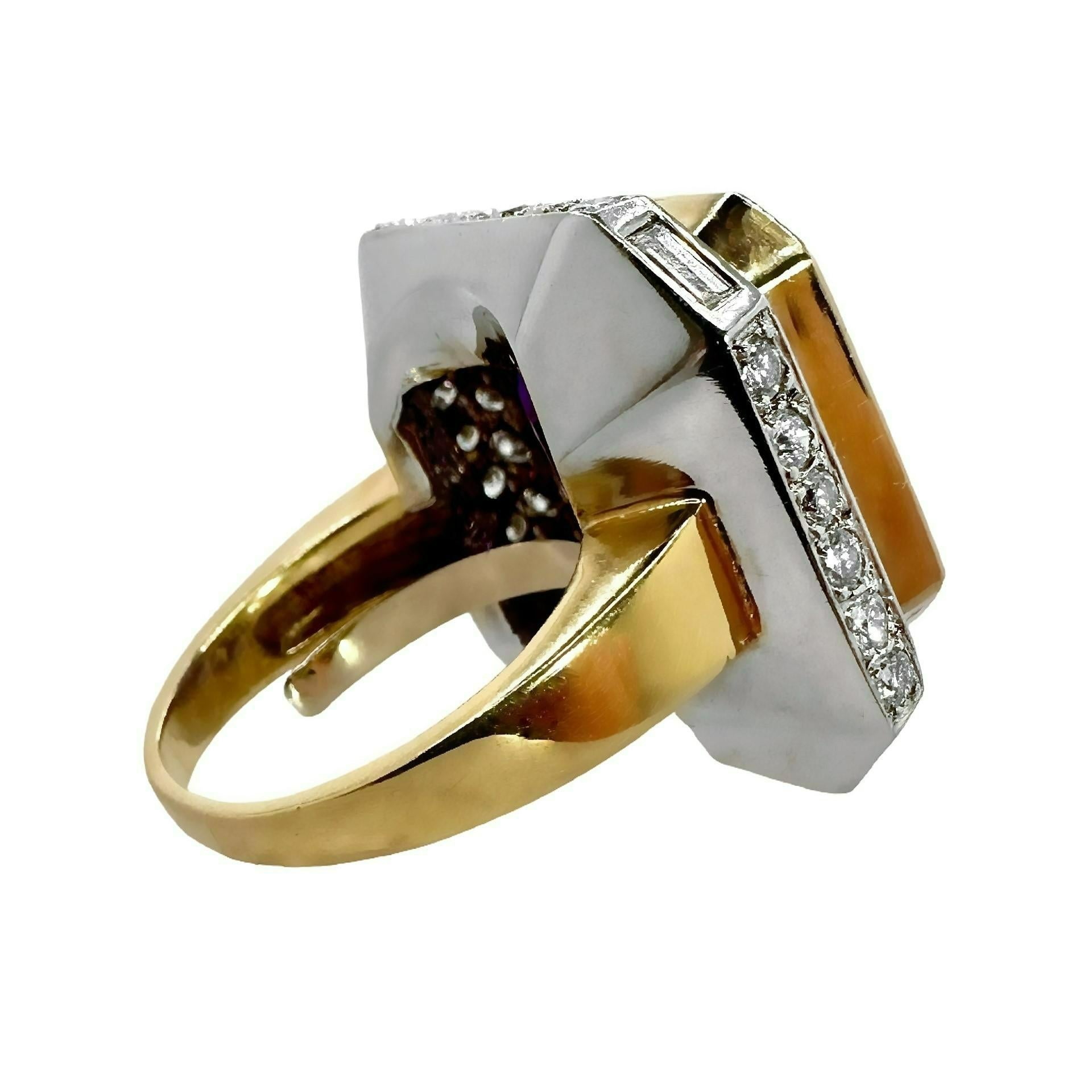 The scale of this beauty makes a big statement. This large 1970's ring, features one center emerald cut amethyst set in 18k yellow gold, surrounded by two rows of high quality brilliant cut and emerald cut diamonds set in 18k white gold. The