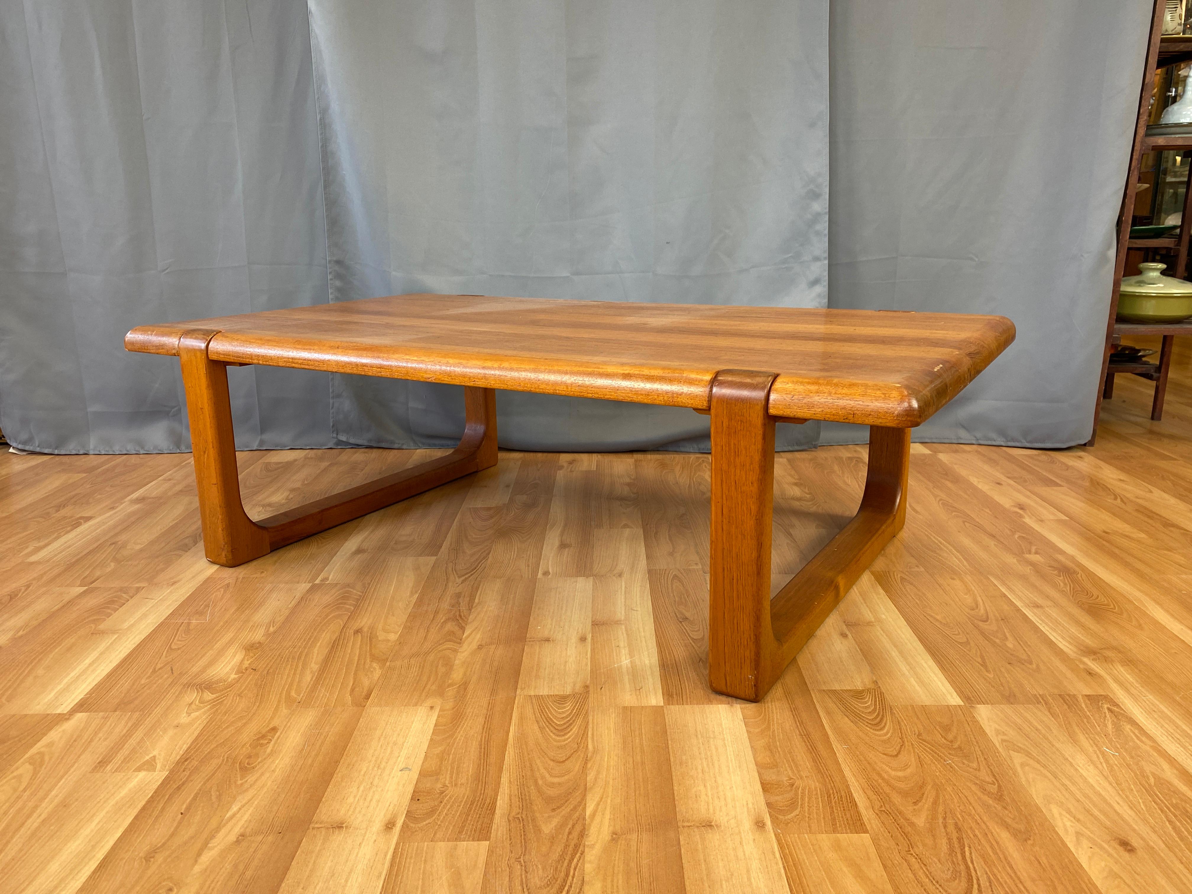 Offered here is a substantial 1970s Danish solid teak coffee or cocktail table by Niels Bach. Strong 
