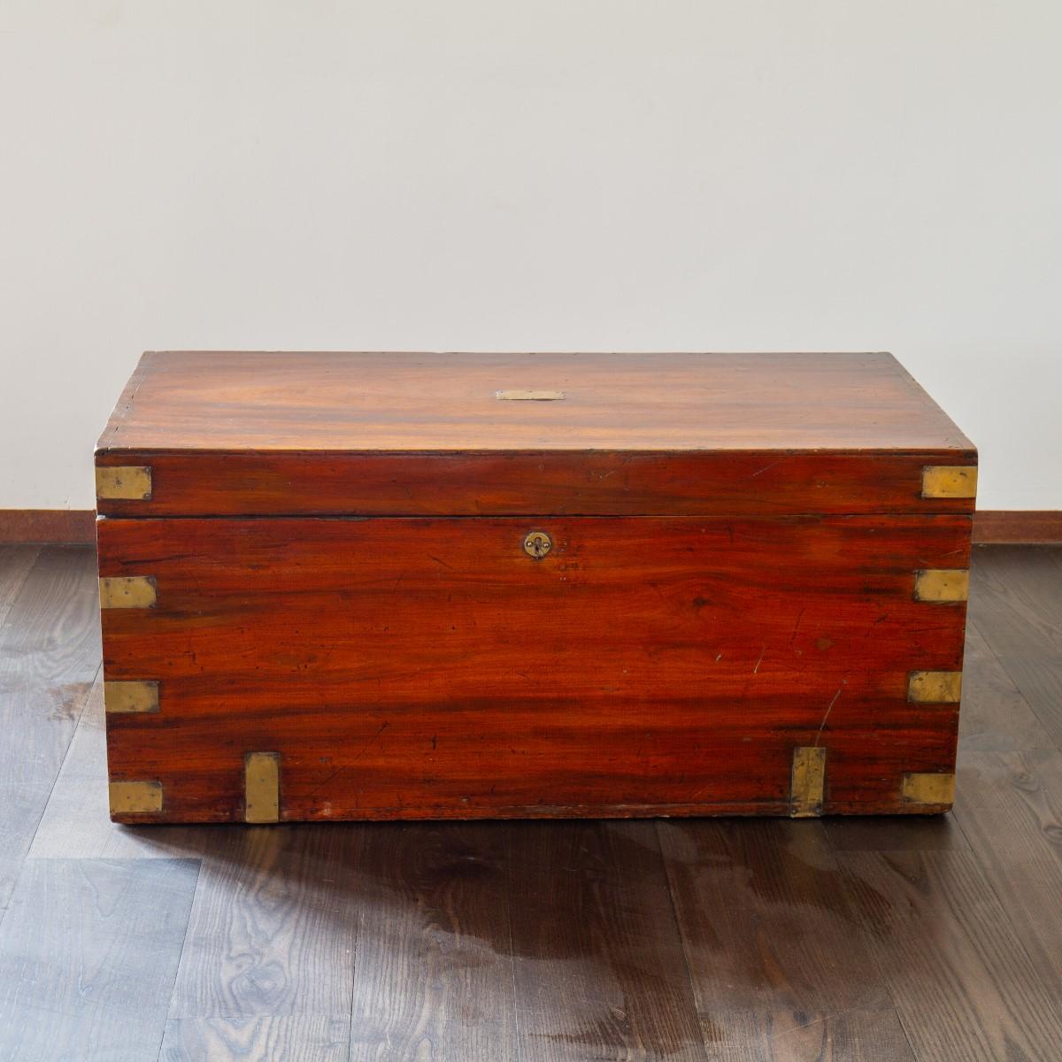 A 19th century brass bound camphor wood trunk with original brass lock, carrying handles and a brass plaque of ownership inscribed 'Fr G Smith’. Key included. Camphor wood was used in campaign furniture especially due to its durable density and