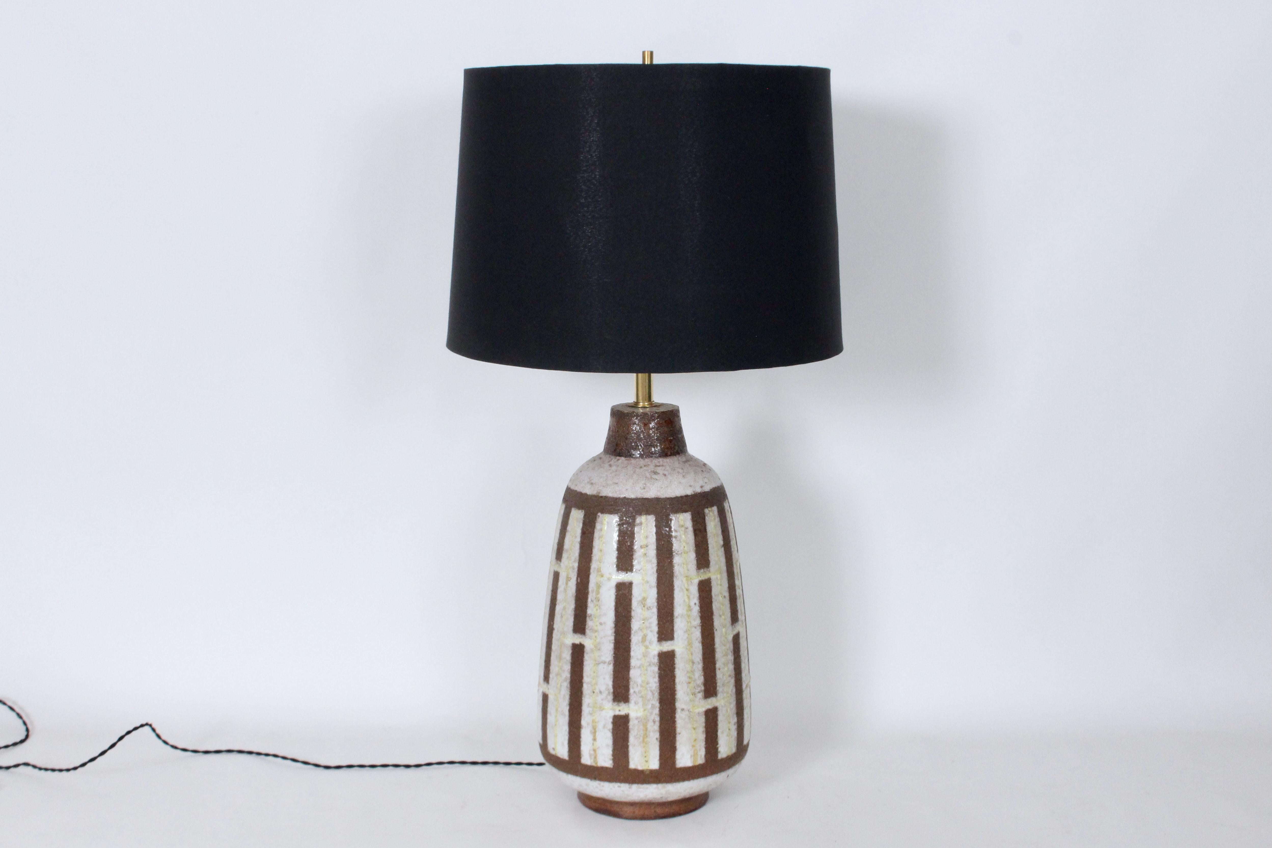 Larger Aldo for Bitossi Deep Brown & Warm Ivory Linear Pottery Table Lamp. Featuring a handcrafted bottle form, Pale Cream glaze, unglazed vertical line in Fudge Brown vertical line, Light Yellow glazed hand painted vertical bands with cross hatch