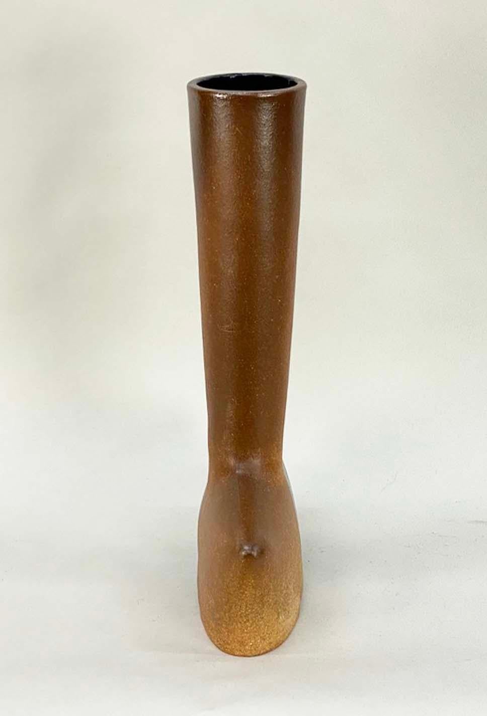 Here's a highly unusual hand-built pottery vase from the 1970s. The sculptural shape is glazed half clear--letting the natural terracotta clay color come through--and half black. The result is a very striking modernist vase that's functional