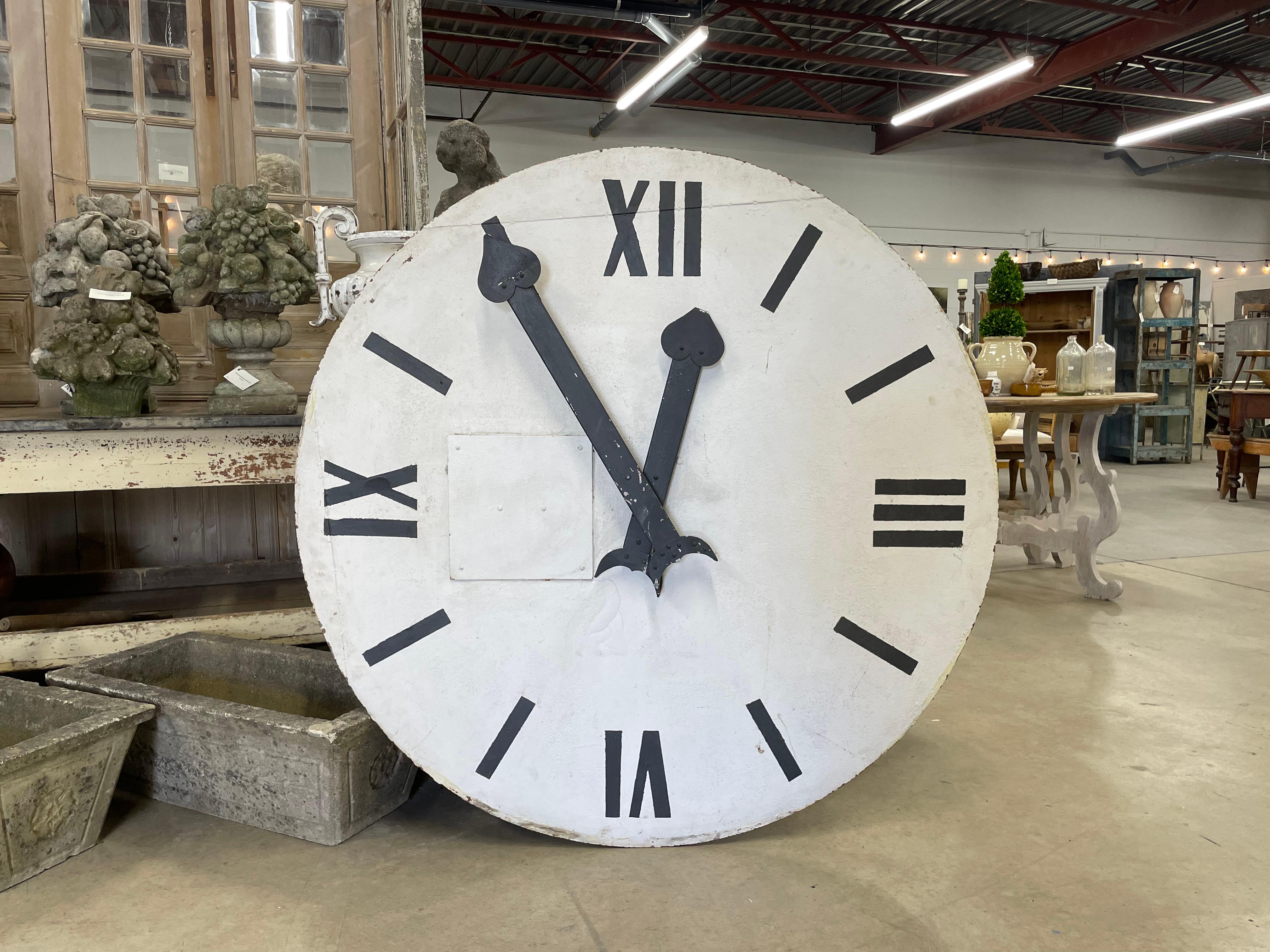 This is a substantial antique metal church tower clock face.

The Roman numerals are hand painted and the clock hands are metal.

The gears ratio to minute and hours but currently non functioning.