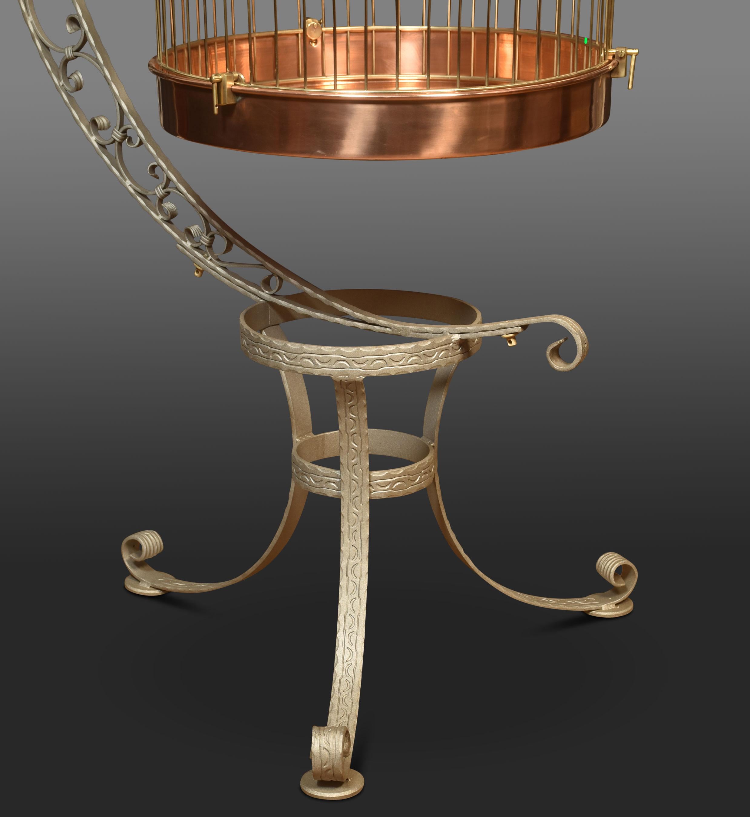 Substantial brass birdcage or aviary, having a dome-shaped cage with copper bottom supported on wrought iron frame with scrolling decoration.
Dimensions
Height 74 inches
Width 32 inches
Depth 41 inches

Cage Dimensions

Height 40