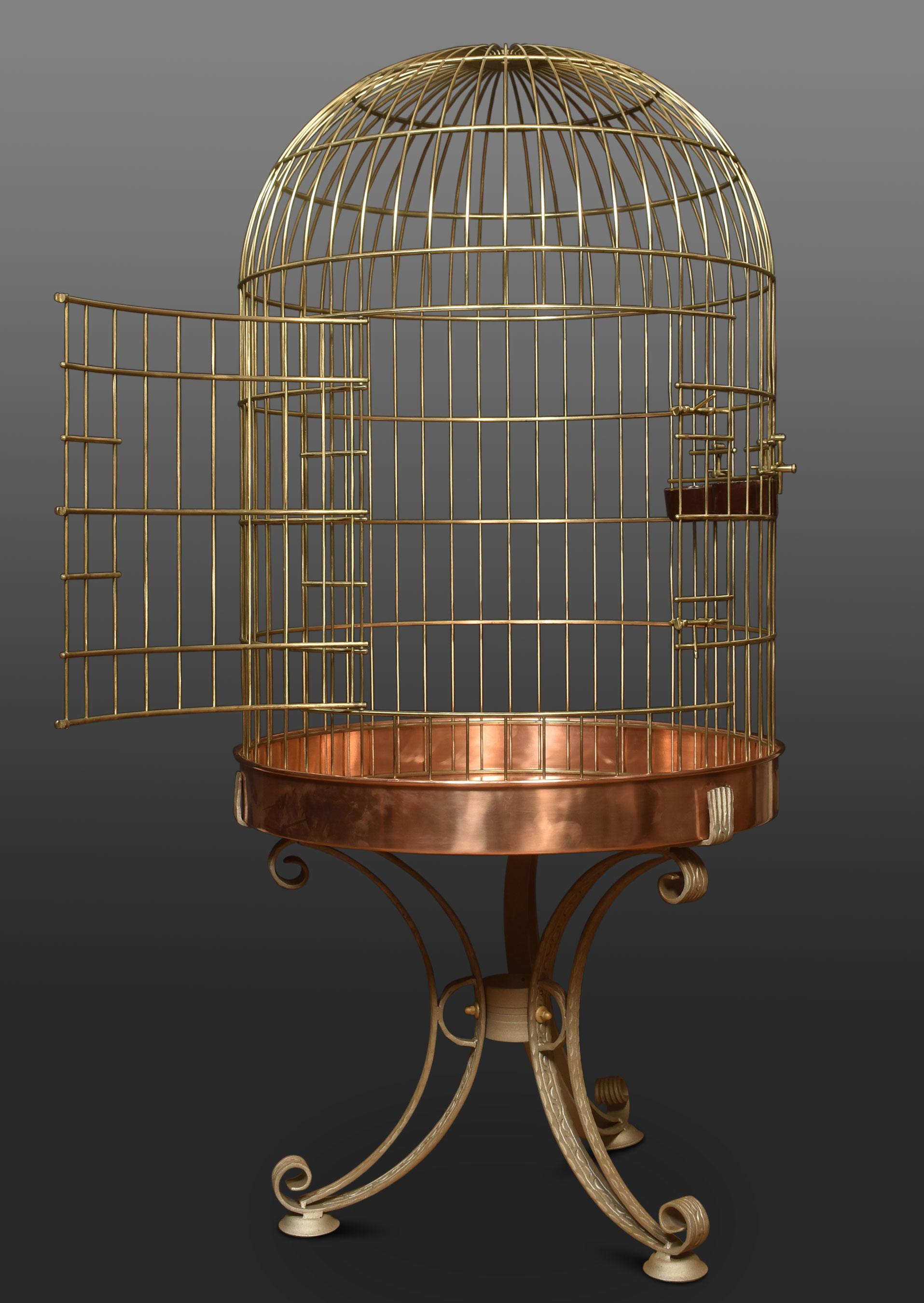 Substantial brass birdcage or aviary, having a dome-shaped cage with copper bottom supported on wrought iron frame.
Dimensions
Height 68 inches
Width 31.5 inches
Depth 31.5 inches.

Cage dimensions
Height 44 inches
Width 31.5 inches
Depth