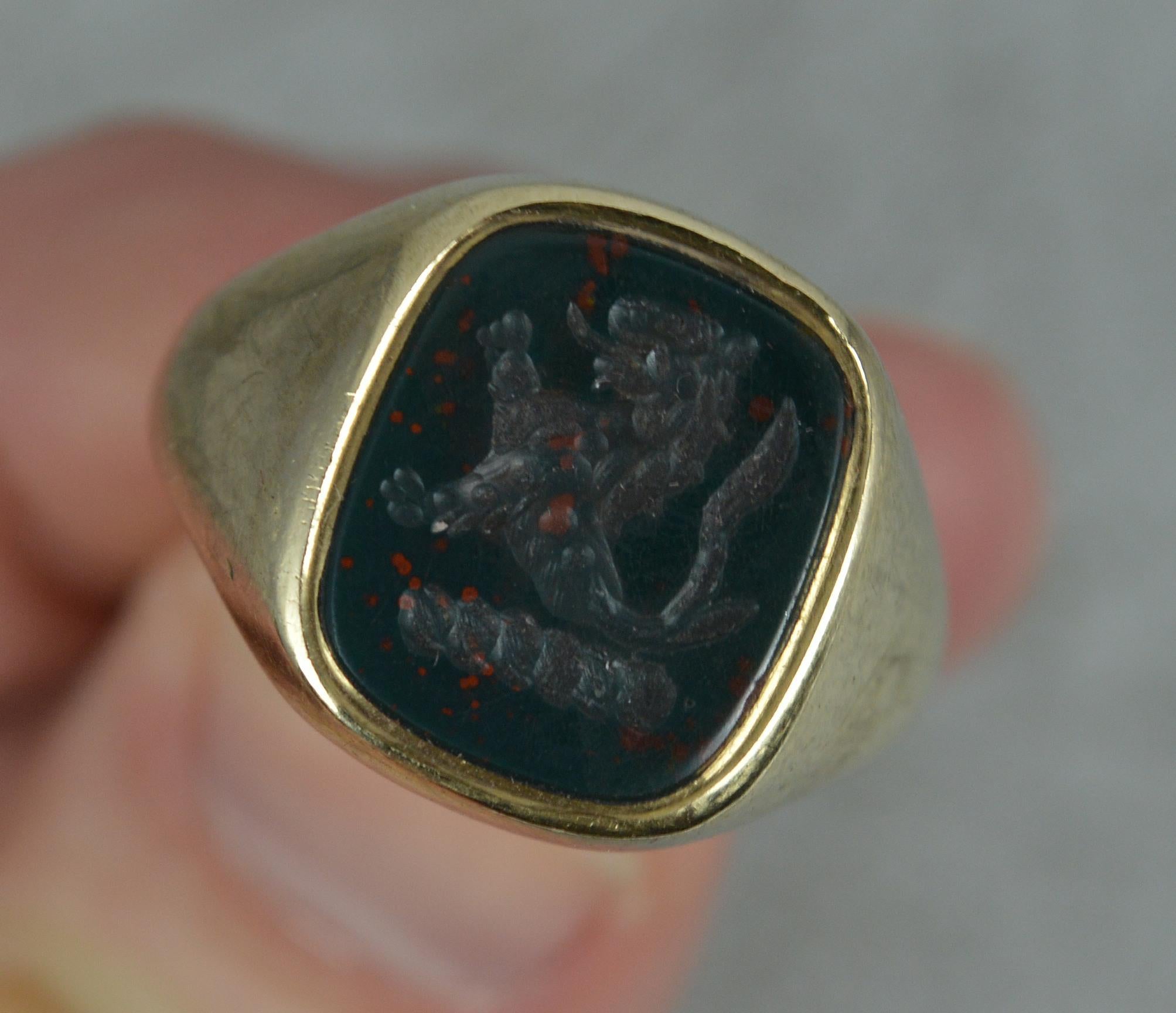 A superb quality signet intaglio ring.
Solid 9 carat yellow gold example.
Set with an oval shaped bloodstone to centre with intaglio. Very finely hand carved example. Lion passant design.
11.8mm x 13.9mm stone.

CONDITION ; Very good. Clean solid