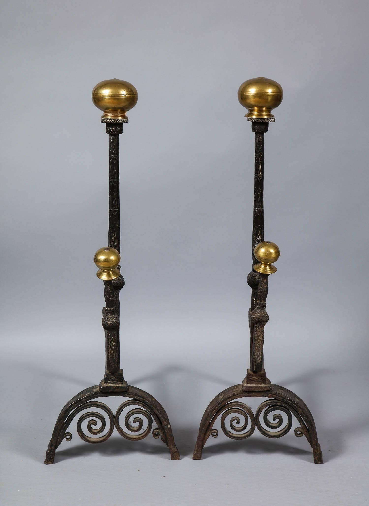 Fine pair of late 17th-early 18th century bronze and wrought iron andirons, the suppressed ball finials over hand-forged upper shafts with matching spit support, on hand-forged shafts decorated with incised linework, on arched feet with under