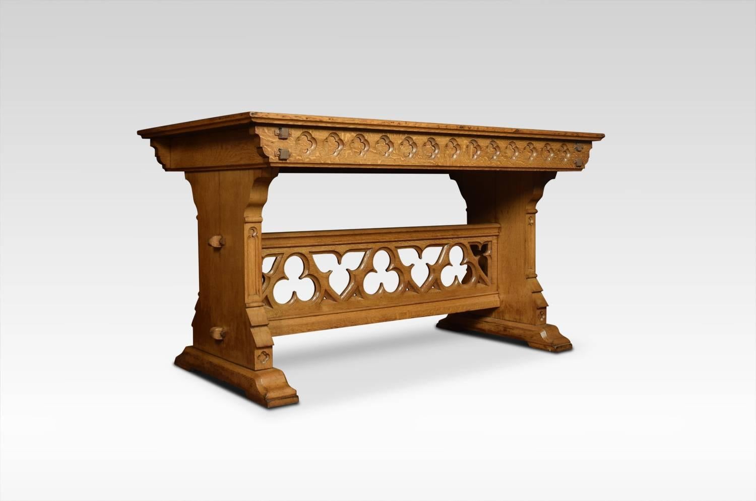 Substantial oak alter / hall table, of architectural form with very large rectangular top, above pierced Gothic freeze raised on trestle legs united by carved trefoil stretcher.
Dimensions:
Height 36 inches
Length 66 inches
Width 36 inches.