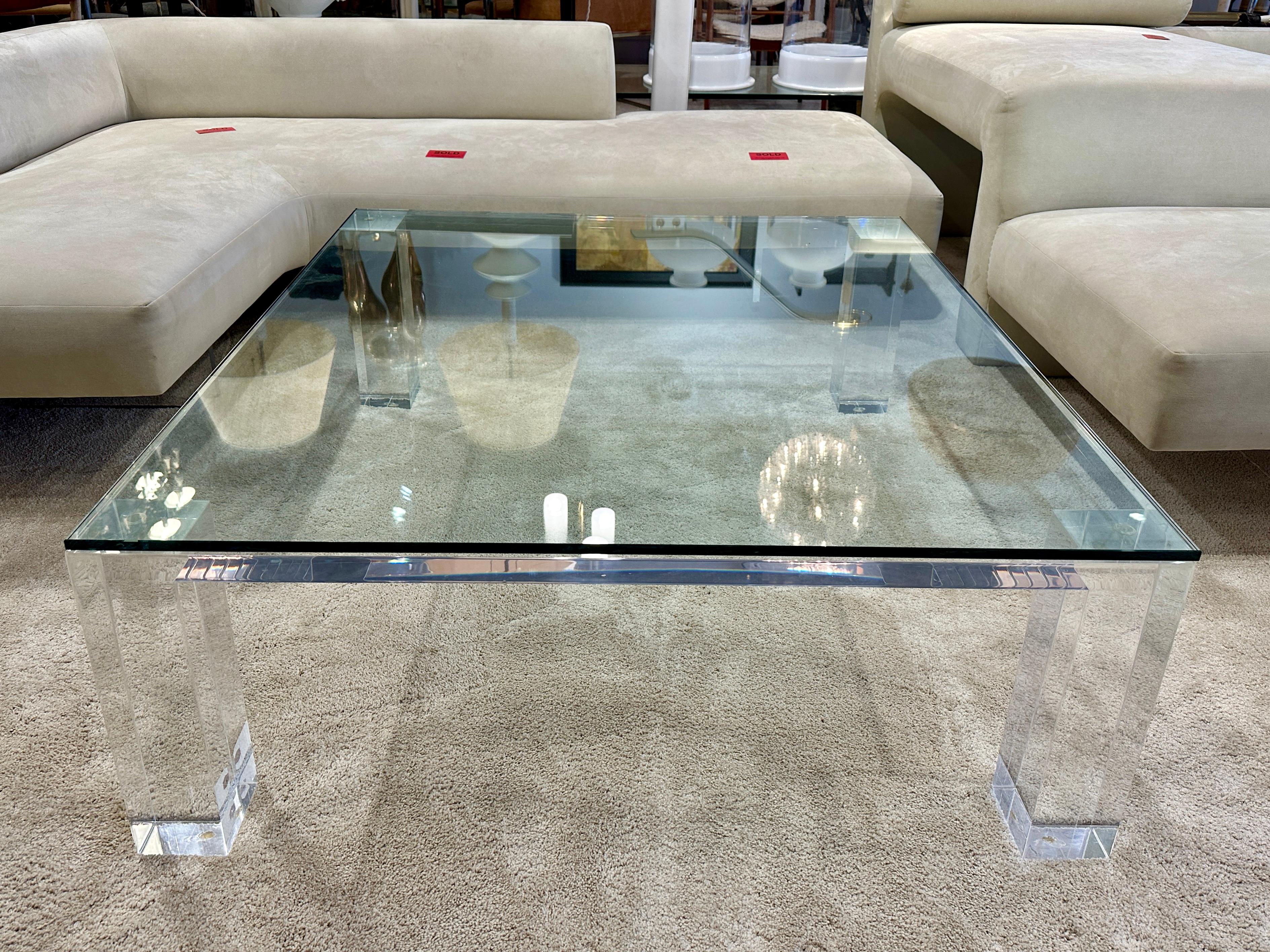 This perfect square coffee table with 4 inch thick legs and 1/2 thick glass top on 1 1/2 inch thick acrylic top. Very sturdy, heavy and important.