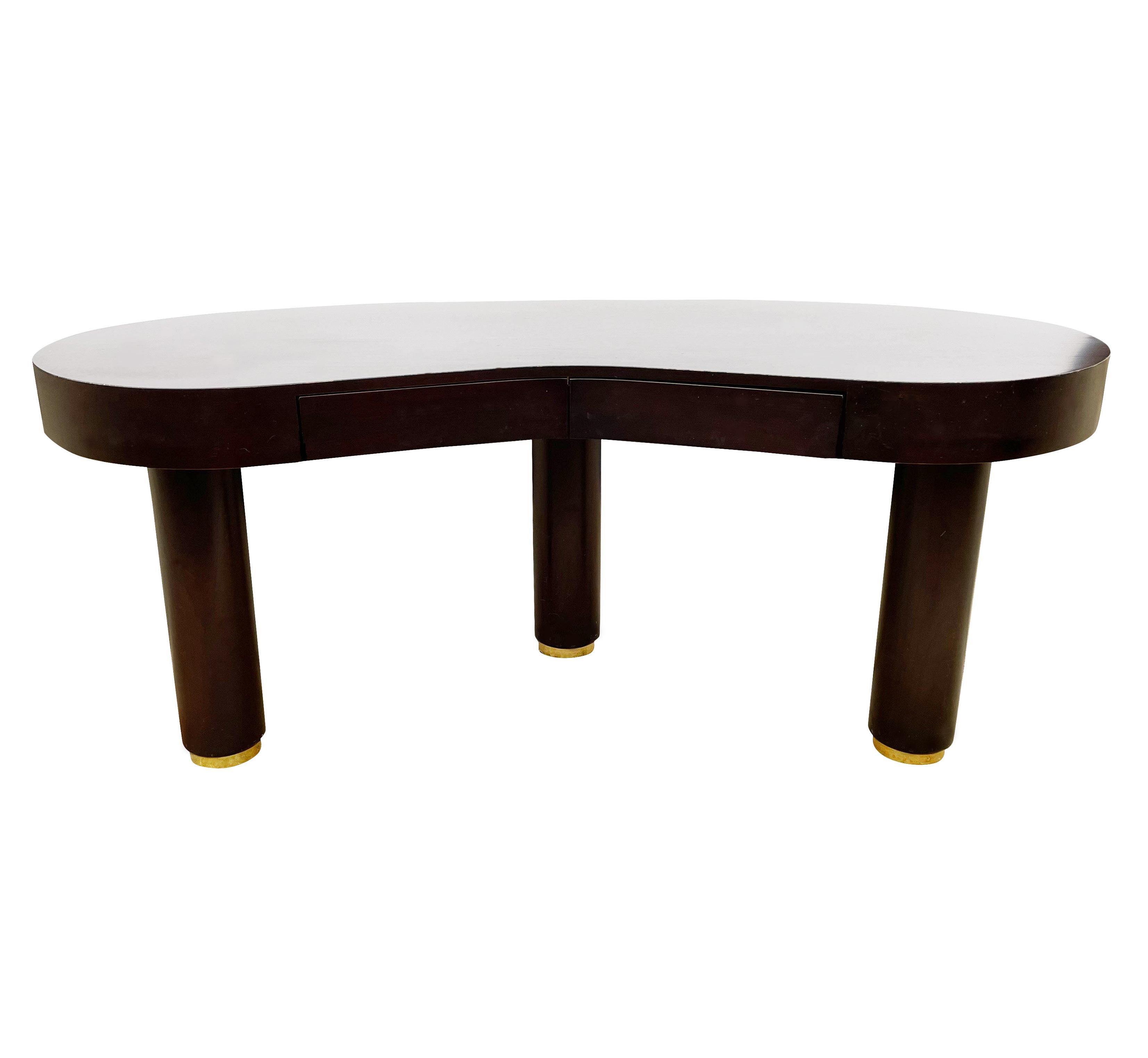 A large stunning custom made kidney shape desk with an Art Deco flair. This desk features dark stained cherry construction, thick chunky legs with brass feet, and two drawers. Very well cared for and ready for immediate use.