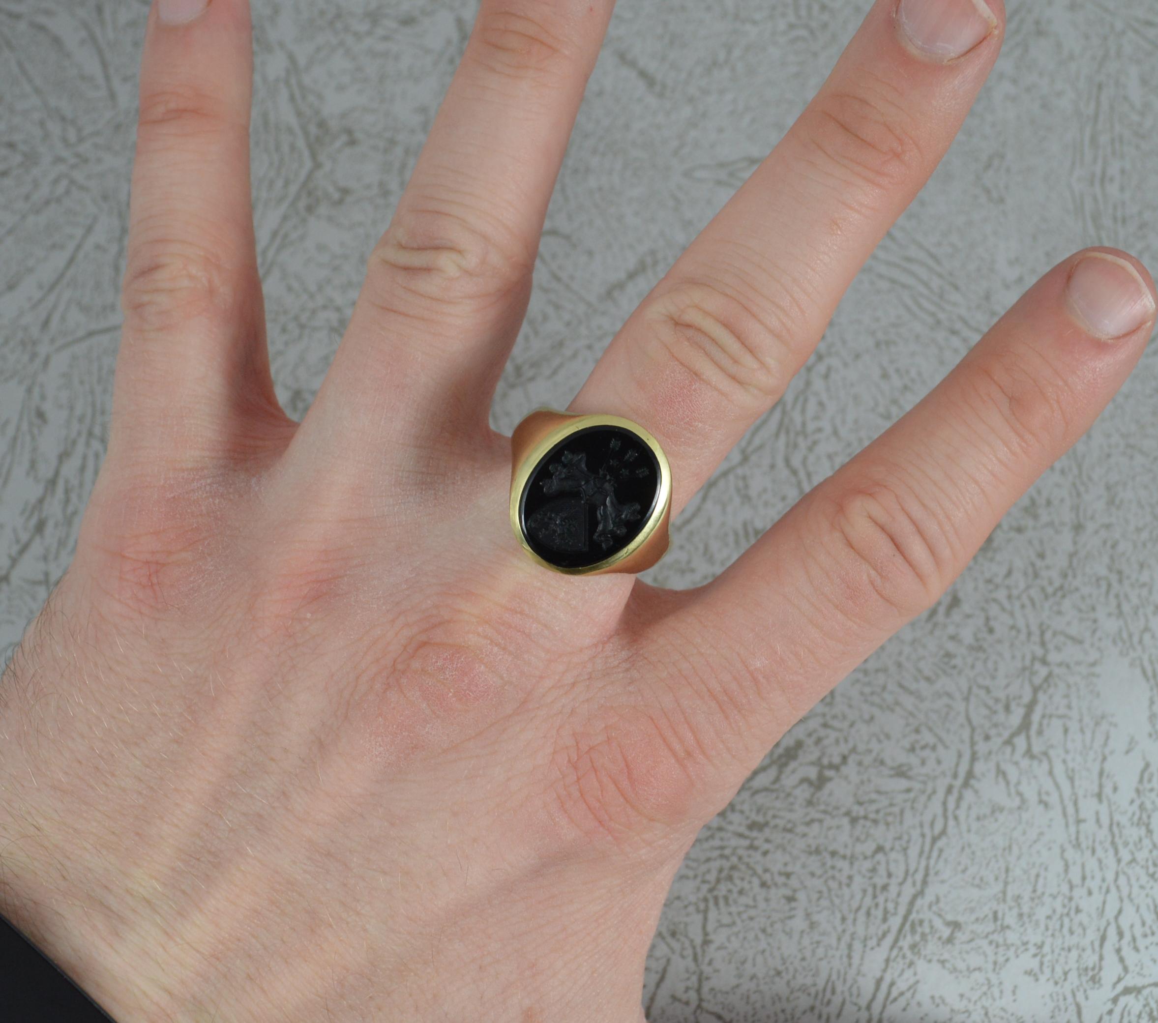 A superb quality signet intaglio ring.
Solid 14 carat yellow gold example.
Set with an oval shaped onyx to centre with intaglio. Very finely hand carved example. Three arrows and two stars to top, stylish centre and a shield below with dragon