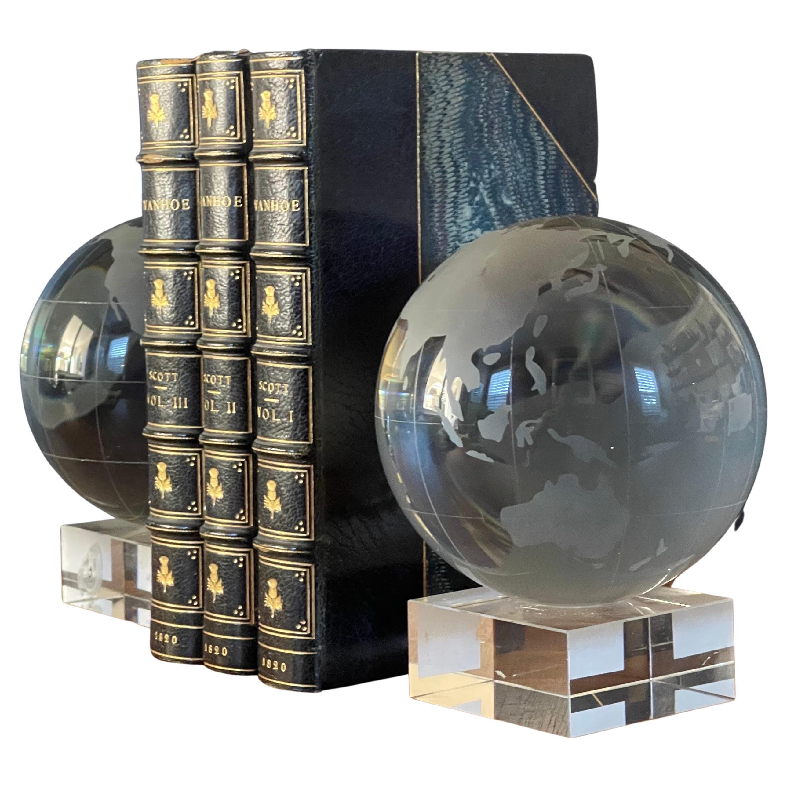 Substantial pair of etched crystal globe bookends by Nicole Miller, circa 2000s. The bookends are in very good vintage condition with no chips or cracks and measure 9.5