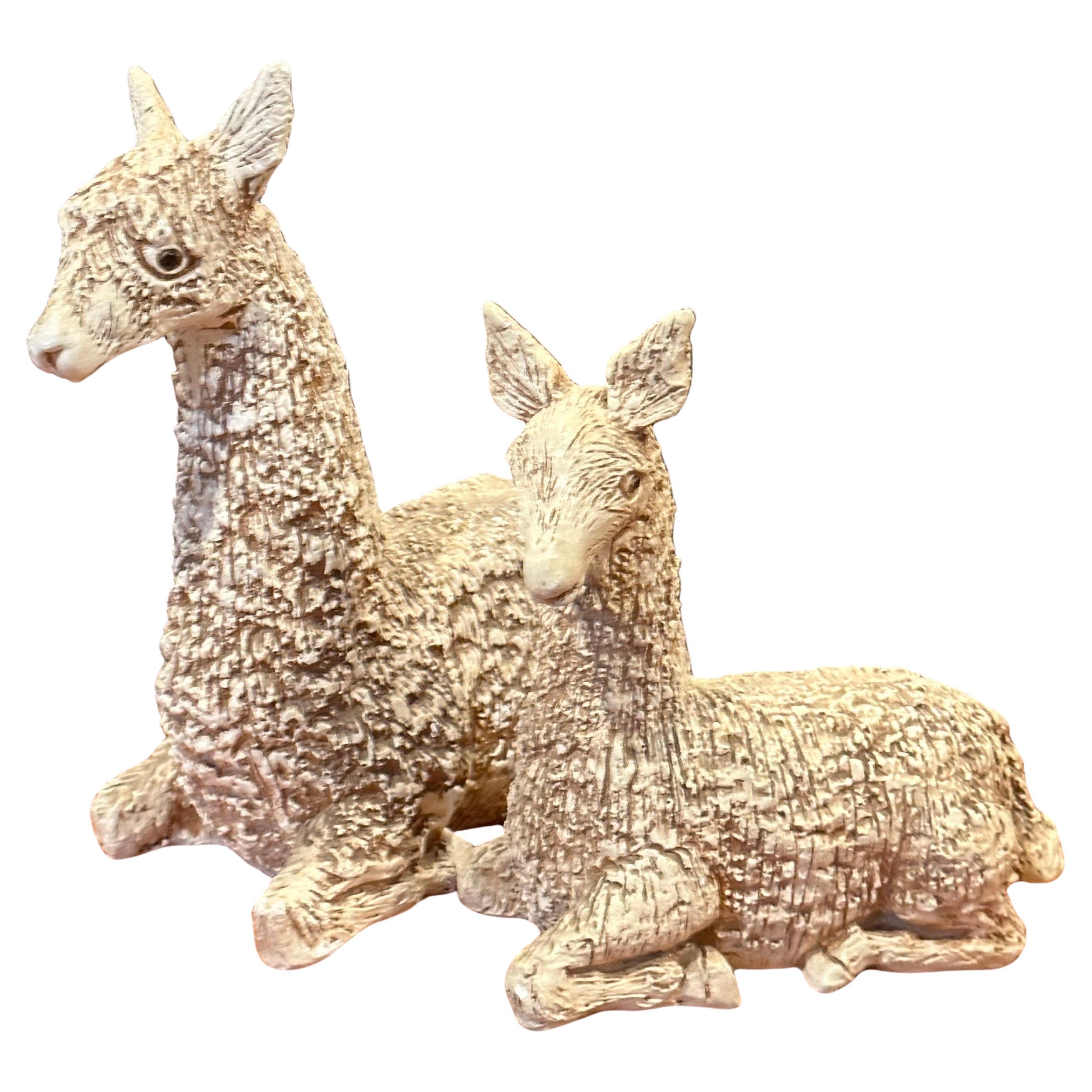 A very cool and substantial pair of mid-century stoneware or plaster llamas by Jaru, circa 1979. Mother and baby llama have been beautifully sculpted with deep striking texture and glazed to bring them to a rich deep beige color.

Mother stands 11