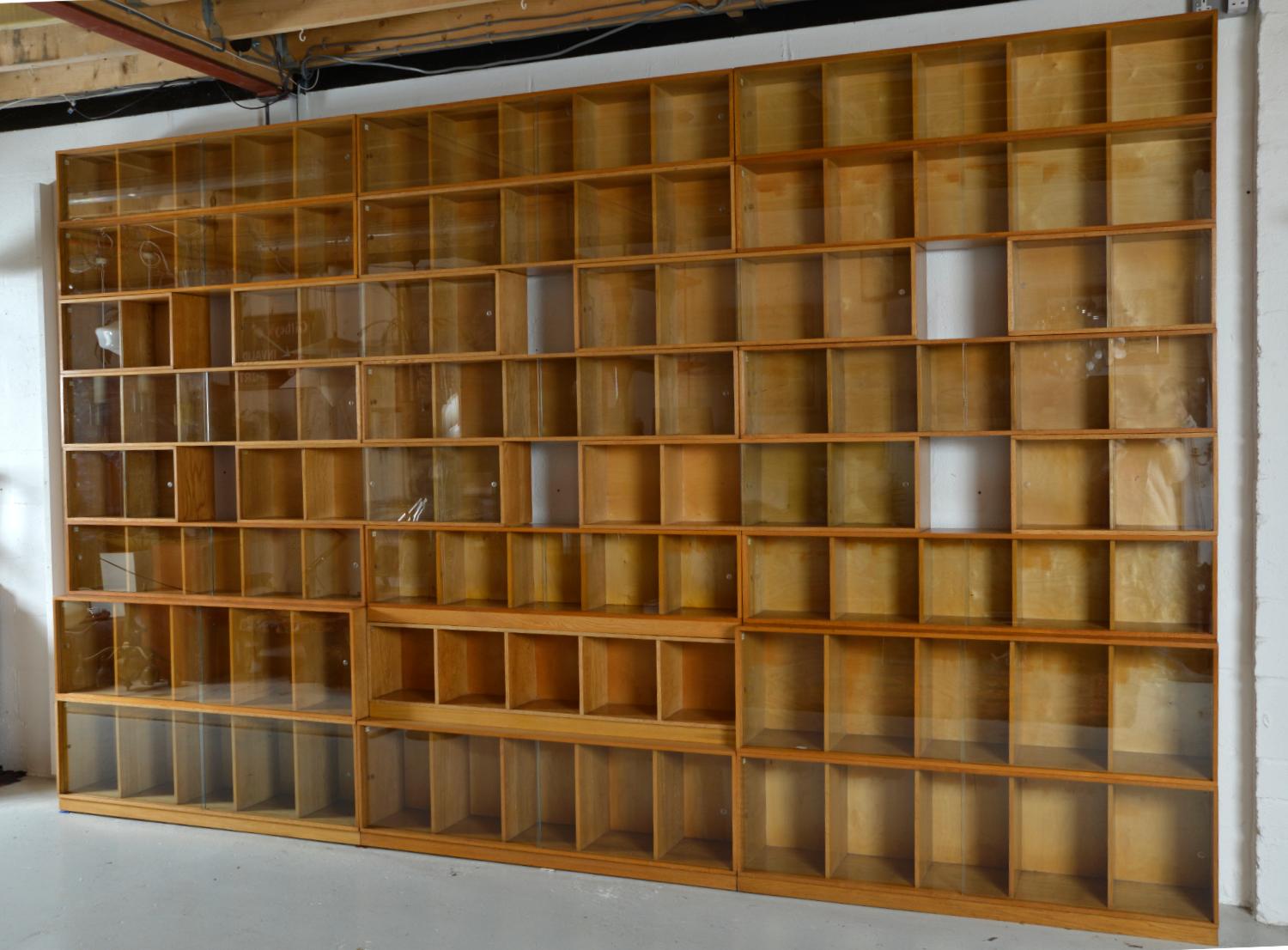 An enormous bank of ‘Unix’ stacking glazed library bookcases, comprising of an impressive 26 sections and 114 boxes to fill!
Retailed by the Phoenix Gallery of St. Martins Lane, Charing Cross, London probably in the late 1940s, early 1950s, made of