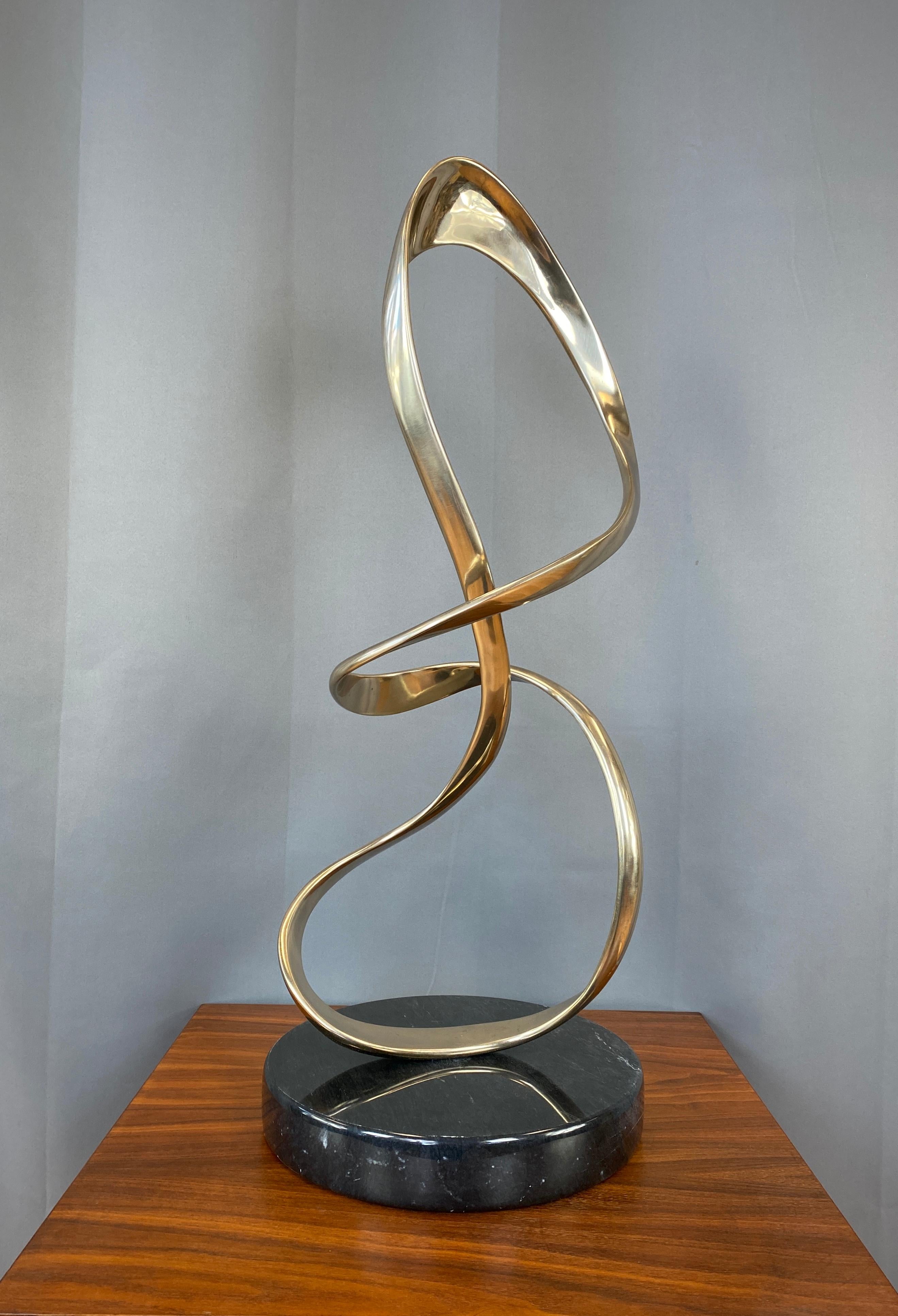 Offered here is a substantial Tom Bennett bronze freeform sculpture with round marble base. Signed and numbered ‘89 14/150

Tom Bennett (death 4-20-16), with his late twin brother late Bob Bennett (death 2006), were Northern California based