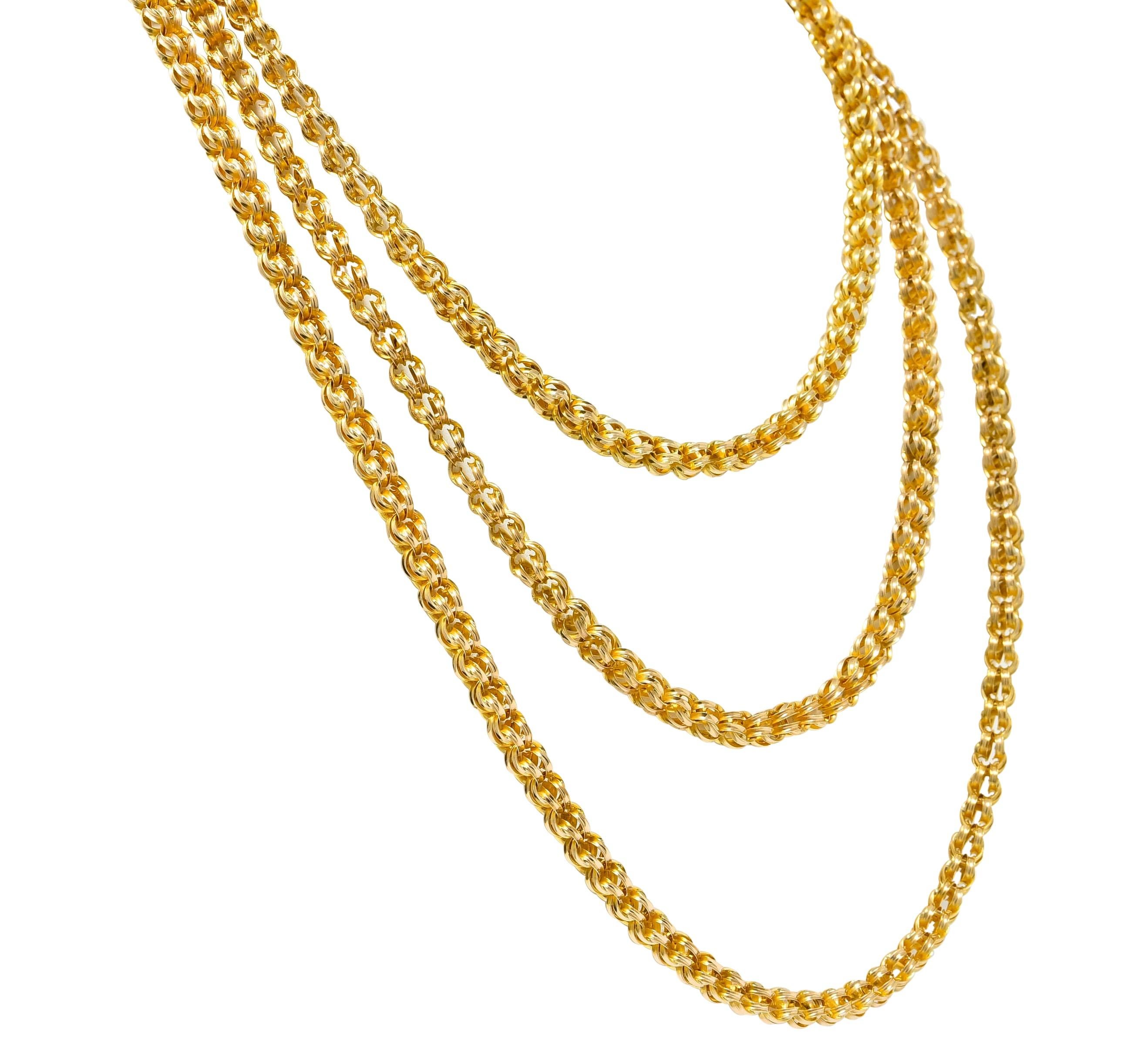 Long chain necklace comprised of two diverging round links, intersecting perpendicularly throughout

Links are grooved with a high polish

Completed by a hinged lobster with ridged yoke

With maker's mark and tested as 14 karat gold

Circa