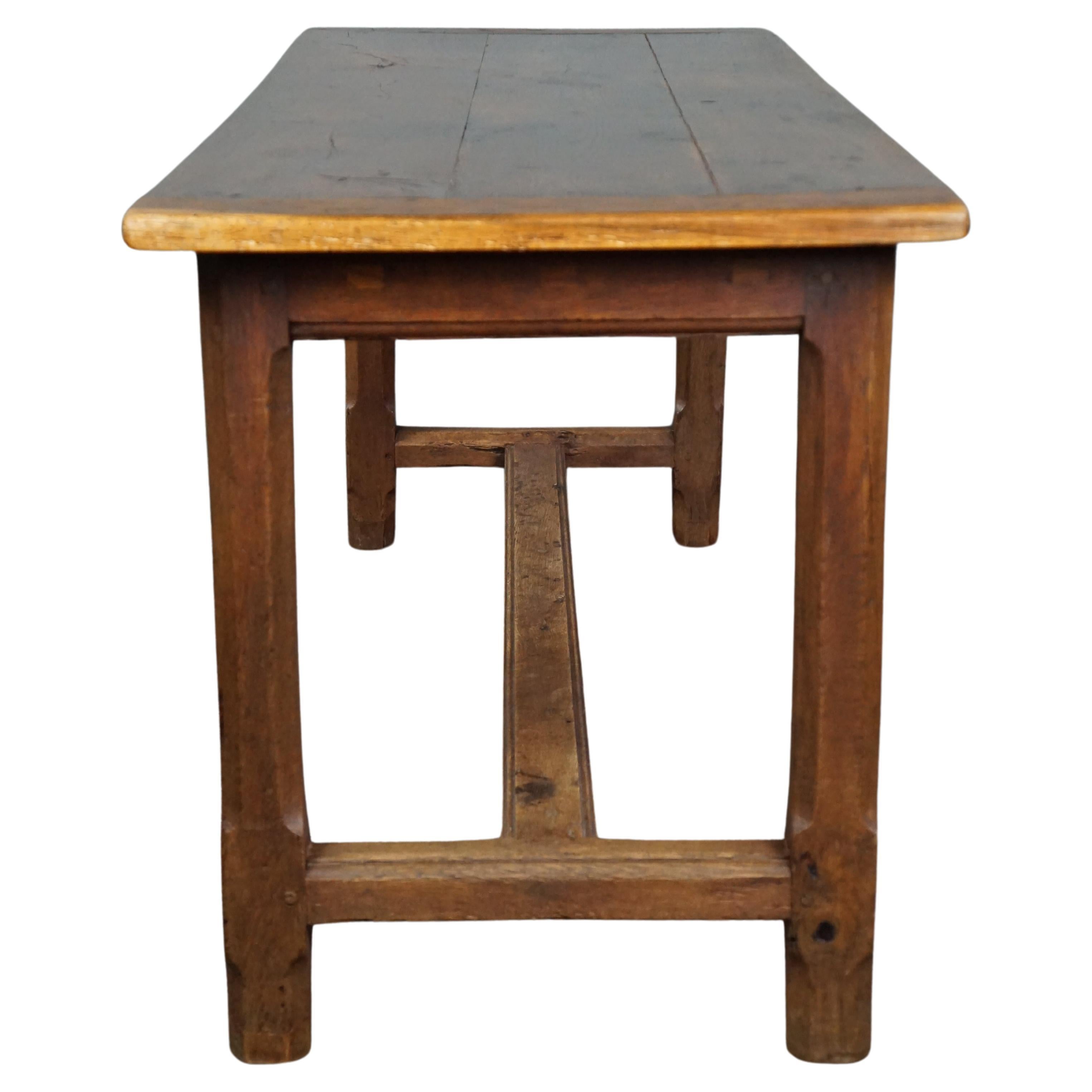 Offered is this sturdy, subtle antique French oak dining table complete with a breadboard and drawer. Do you have limited space in your kitchen or home but still want to enjoy the beautiful and robust appearance of an antique French table? Then you