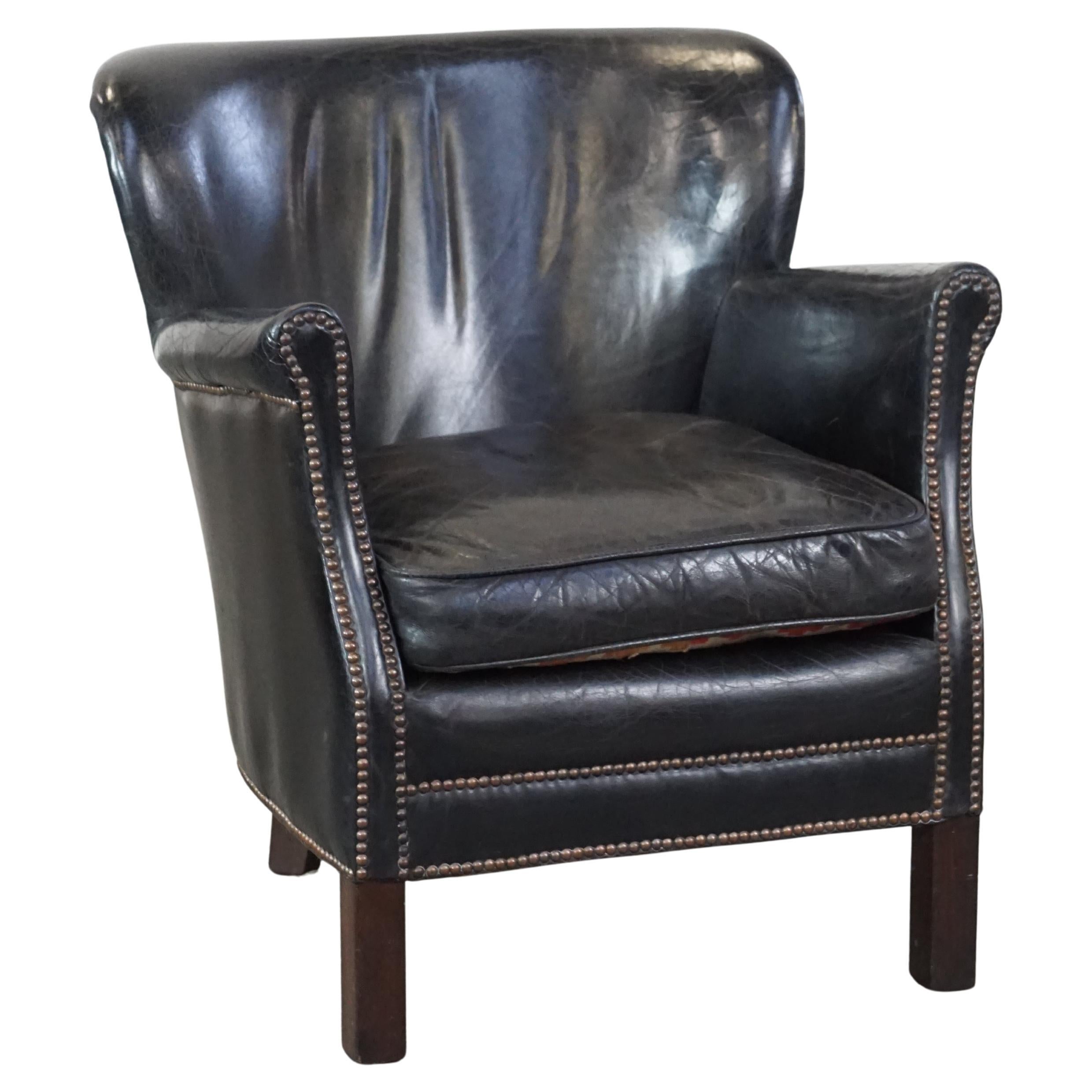 Subtle black armchair with reversible Kelim seat cushion