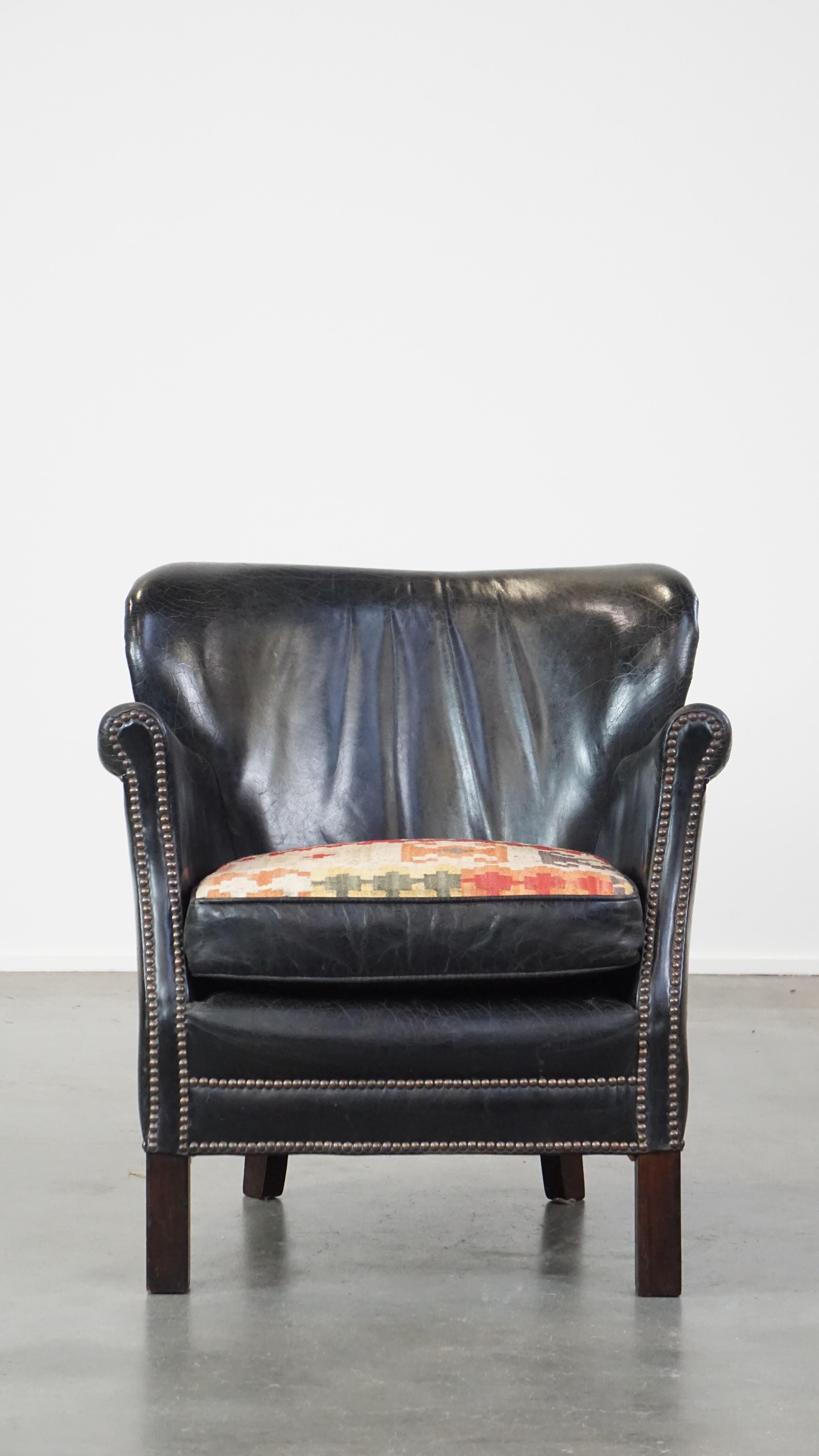 Hand-Crafted Subtle black cow leather armchair with reversible Kelim seat cushion For Sale