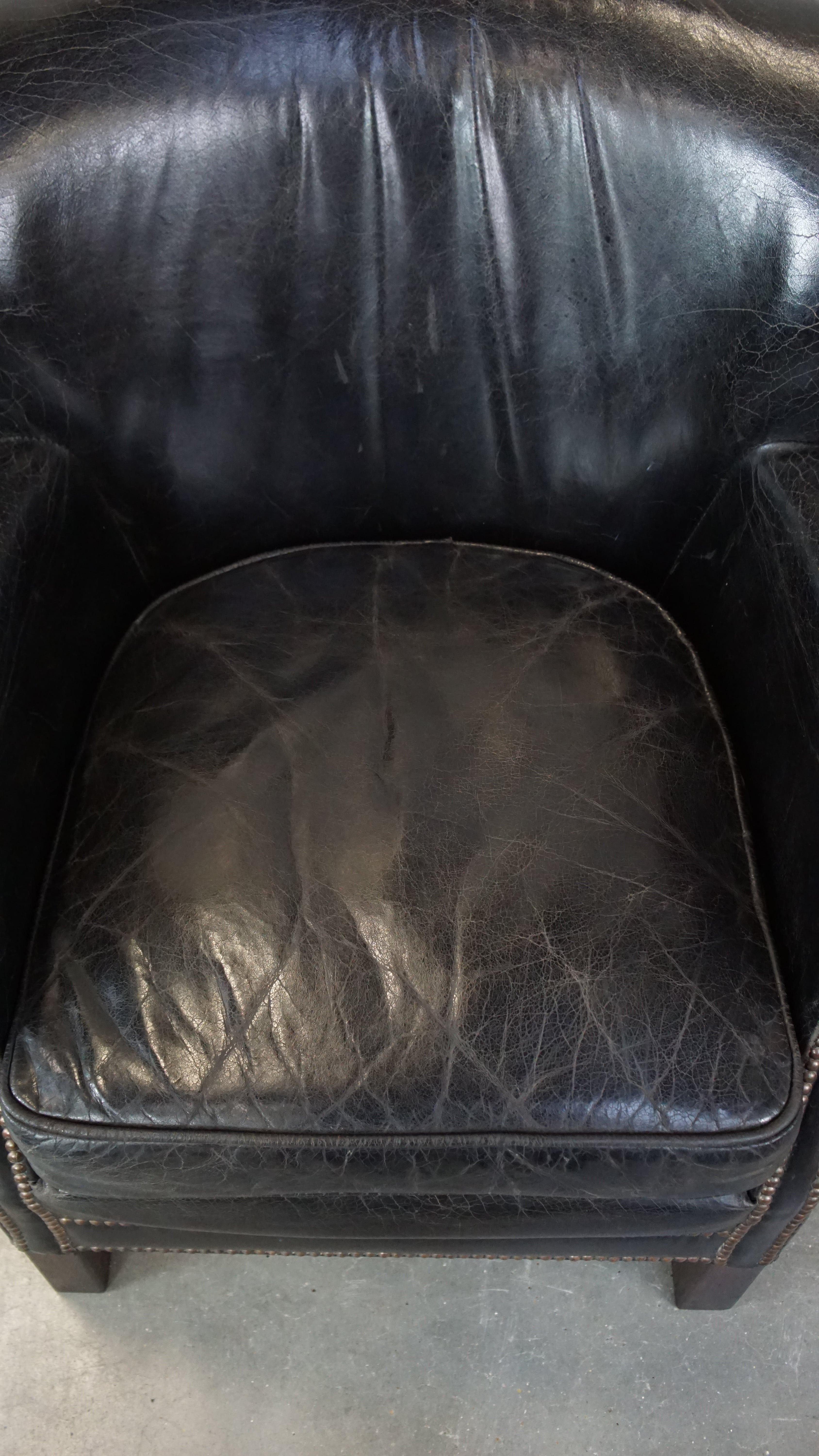 Subtle black cow leather armchair with reversible Kelim seat cushion For Sale 1