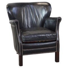 Subtle black cow leather armchair with reversible Kelim seat cushion