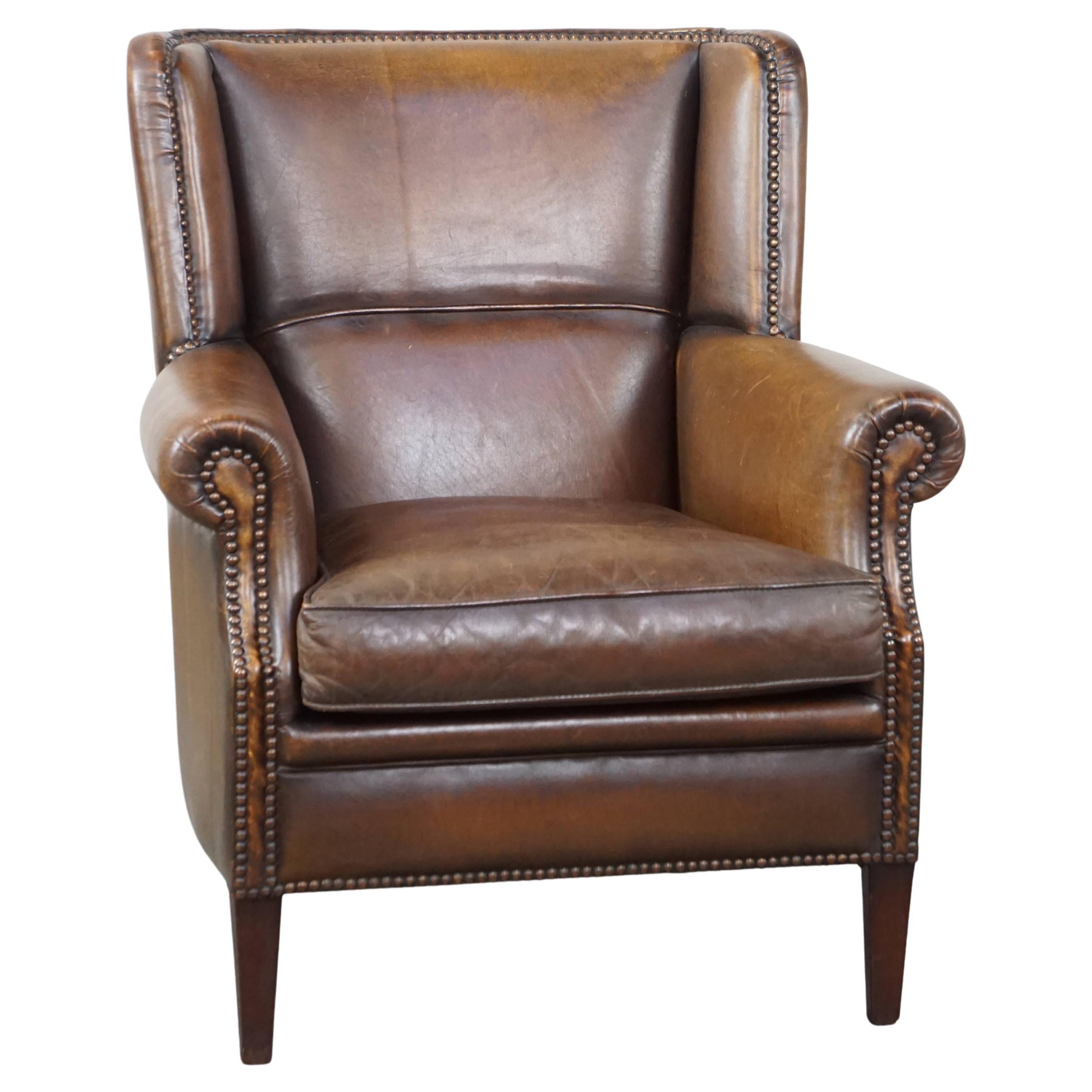 Subtle, comfortable, and well-maintained dark sheepskin leather armchair