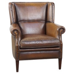 Subtle, comfortable, and well-maintained dark sheepskin leather armchair