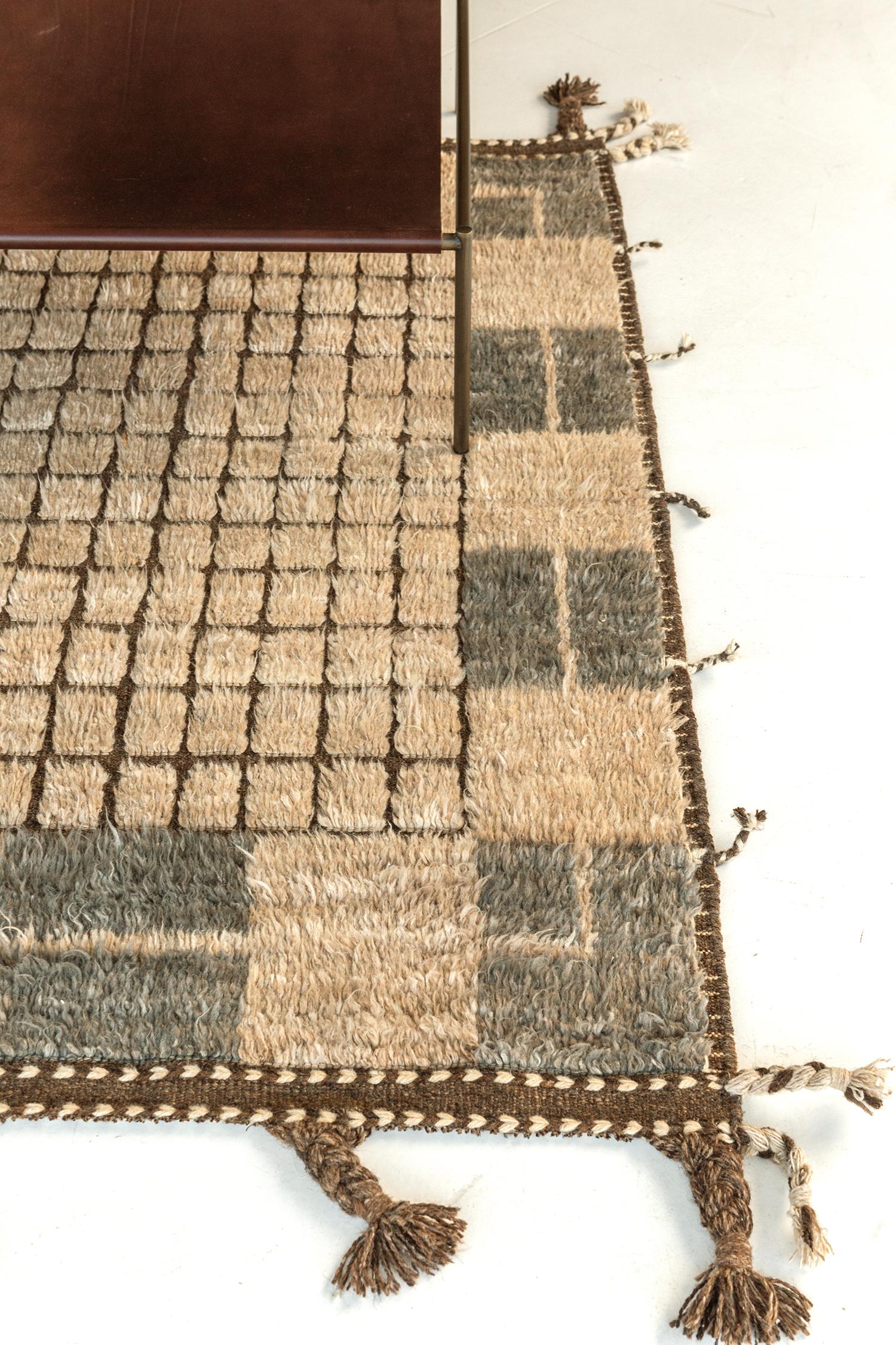 This outstanding mastery of Sudersand rug from the Kust Collection features perfect detailed patterns of charcoal, cream, and chocolate brown outline and fringes and shags. A collection that will light up your space and bring life. Highly